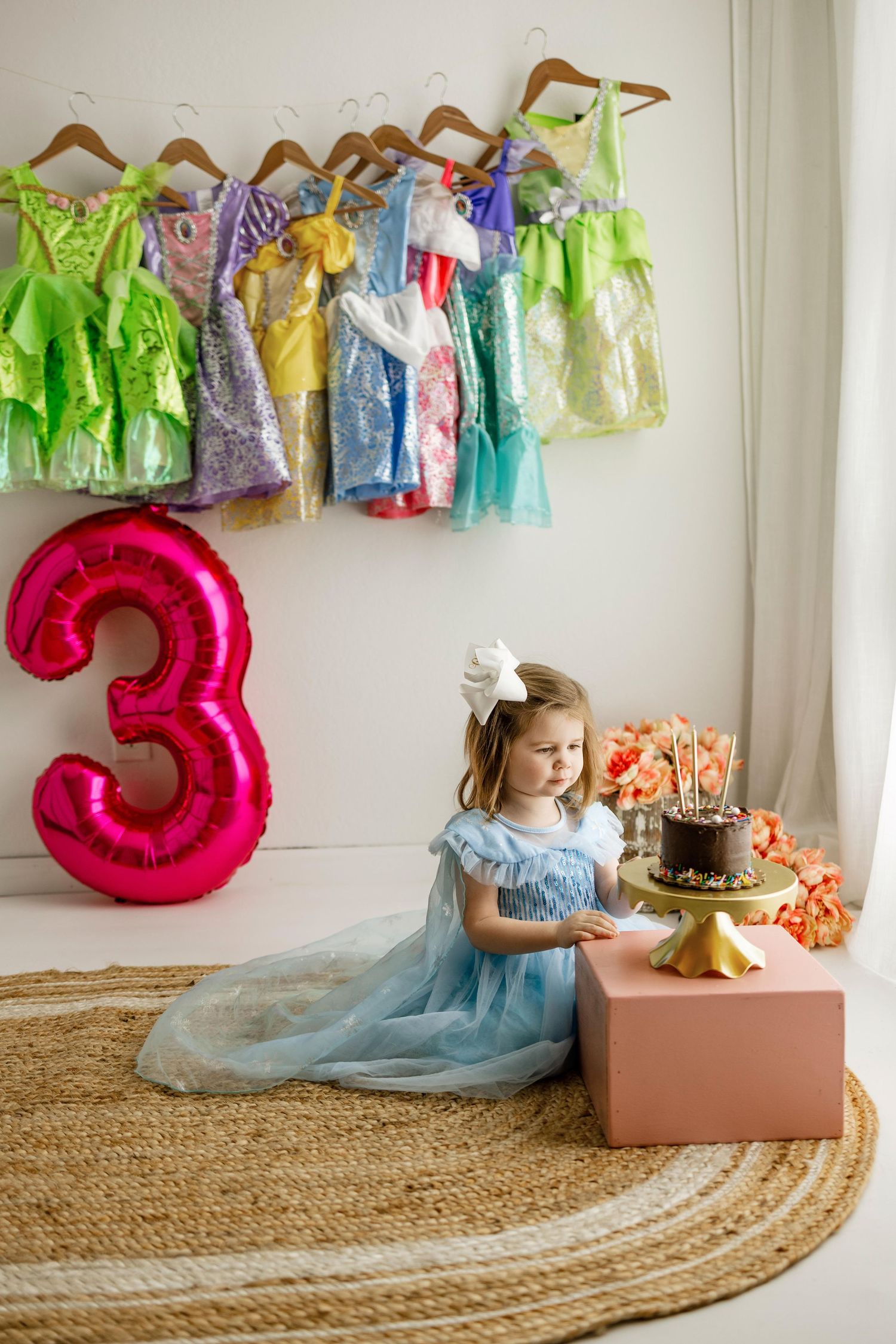A series of photos showing a child in a blue dress opening a birthday gift box with a large red number 3 balloon.