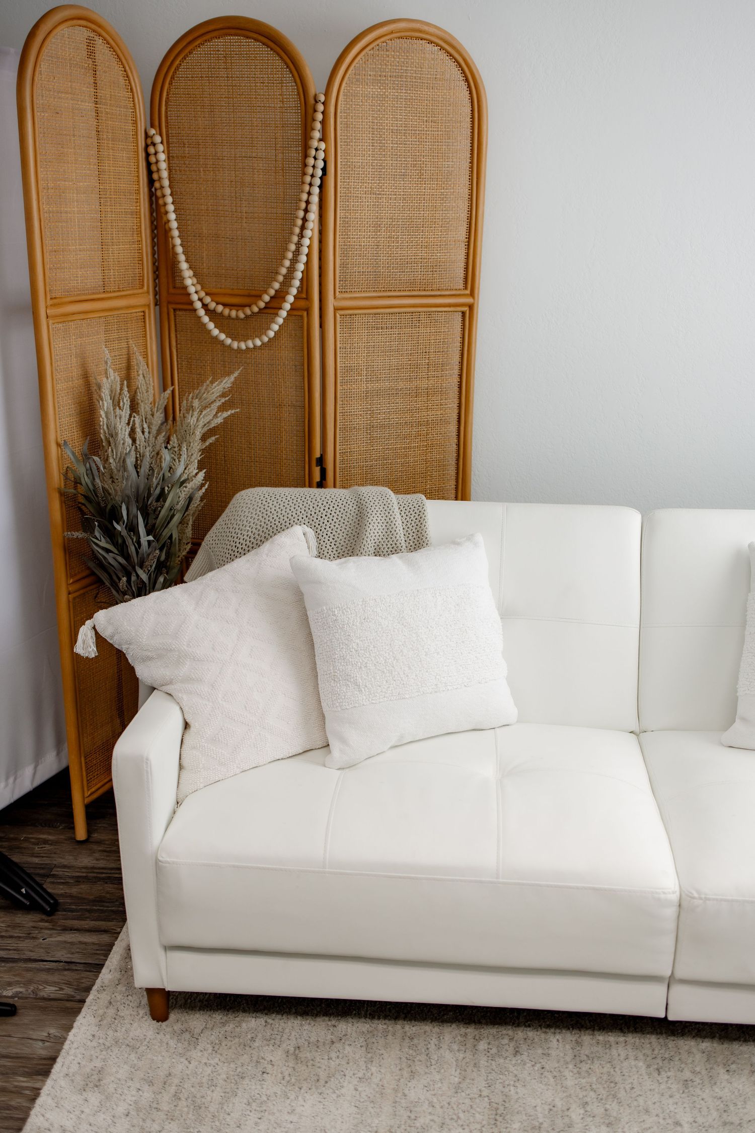 Modern white slipcovered sofa with clean lines and plush cushions shown from different angles against a bamboo screen.