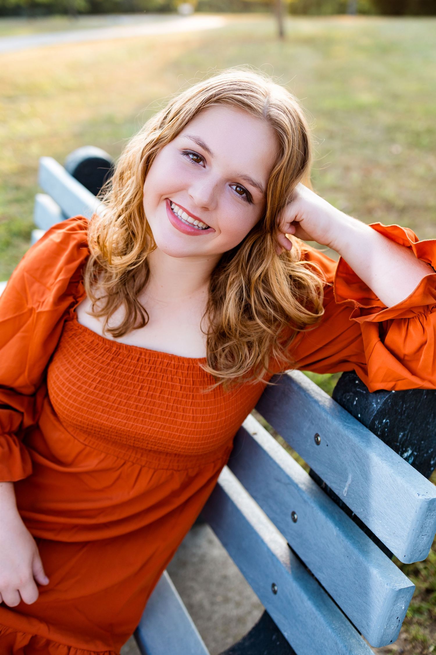 A series of outdoor portrait shots featuring a rust-colored off-shoulder top against a natural background.