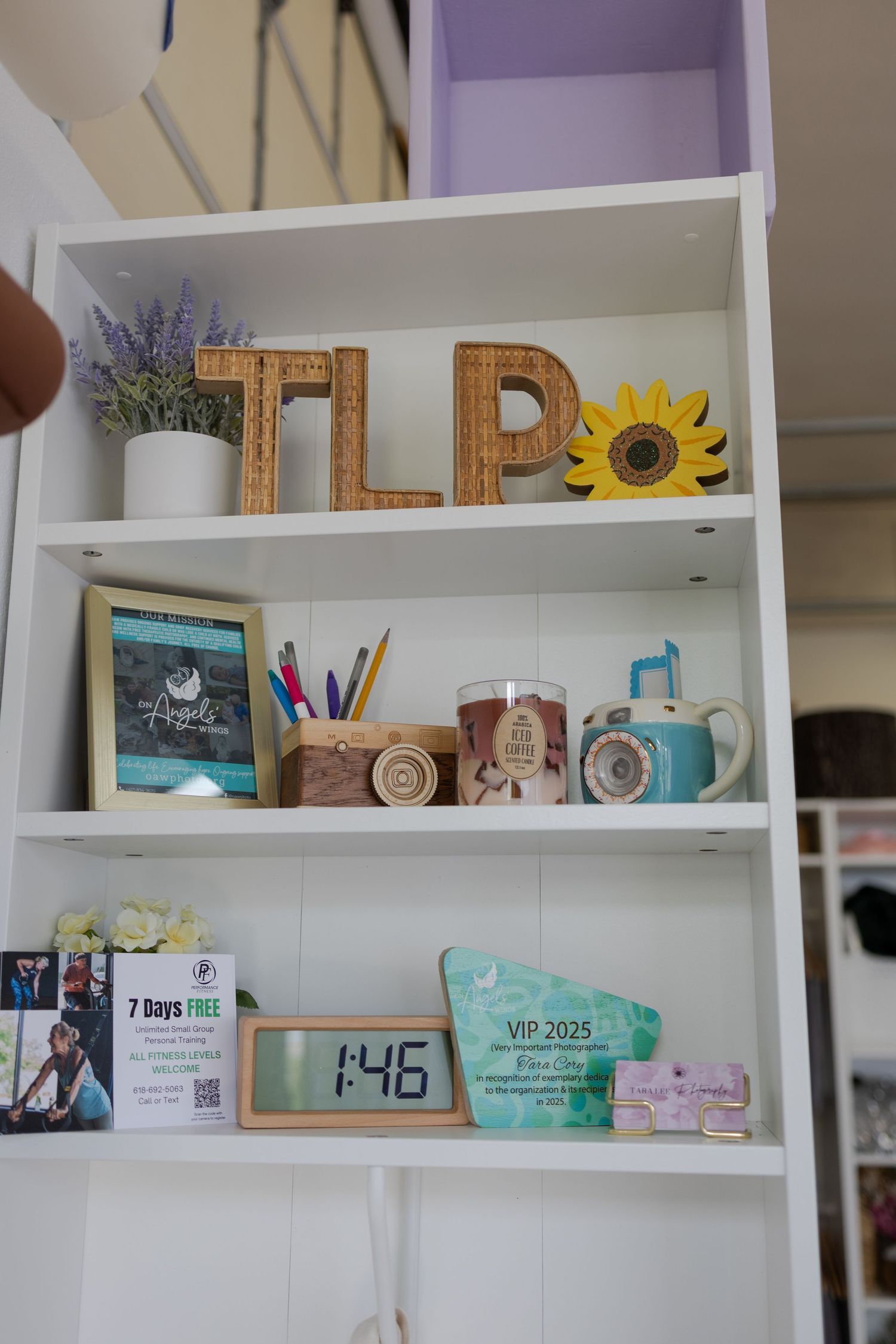 Branded Tara Lee Photography display with studio décor and client details inside the Edwardsville photography studio