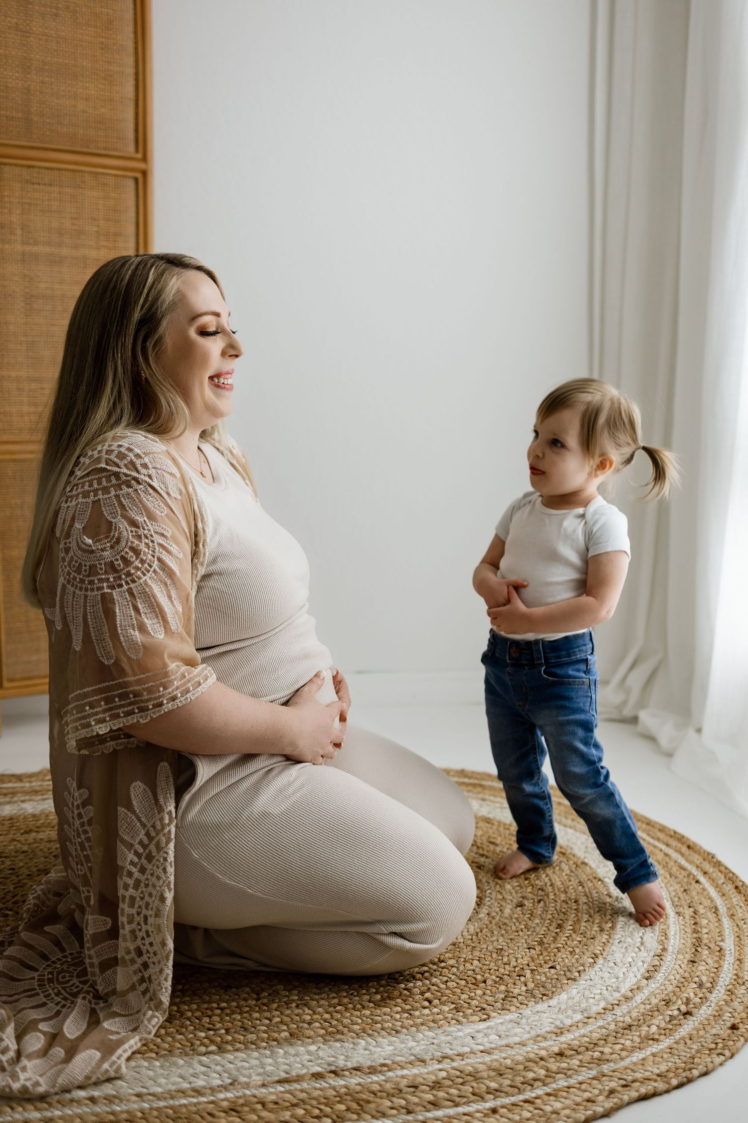 A series of tender moments between parent and child on a round jute rug by a bright window.