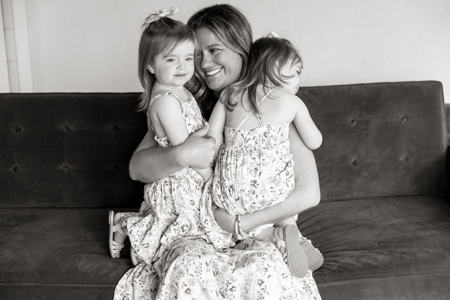 A collection of black and white photographs showing tender moments between two people in matching white dresses.