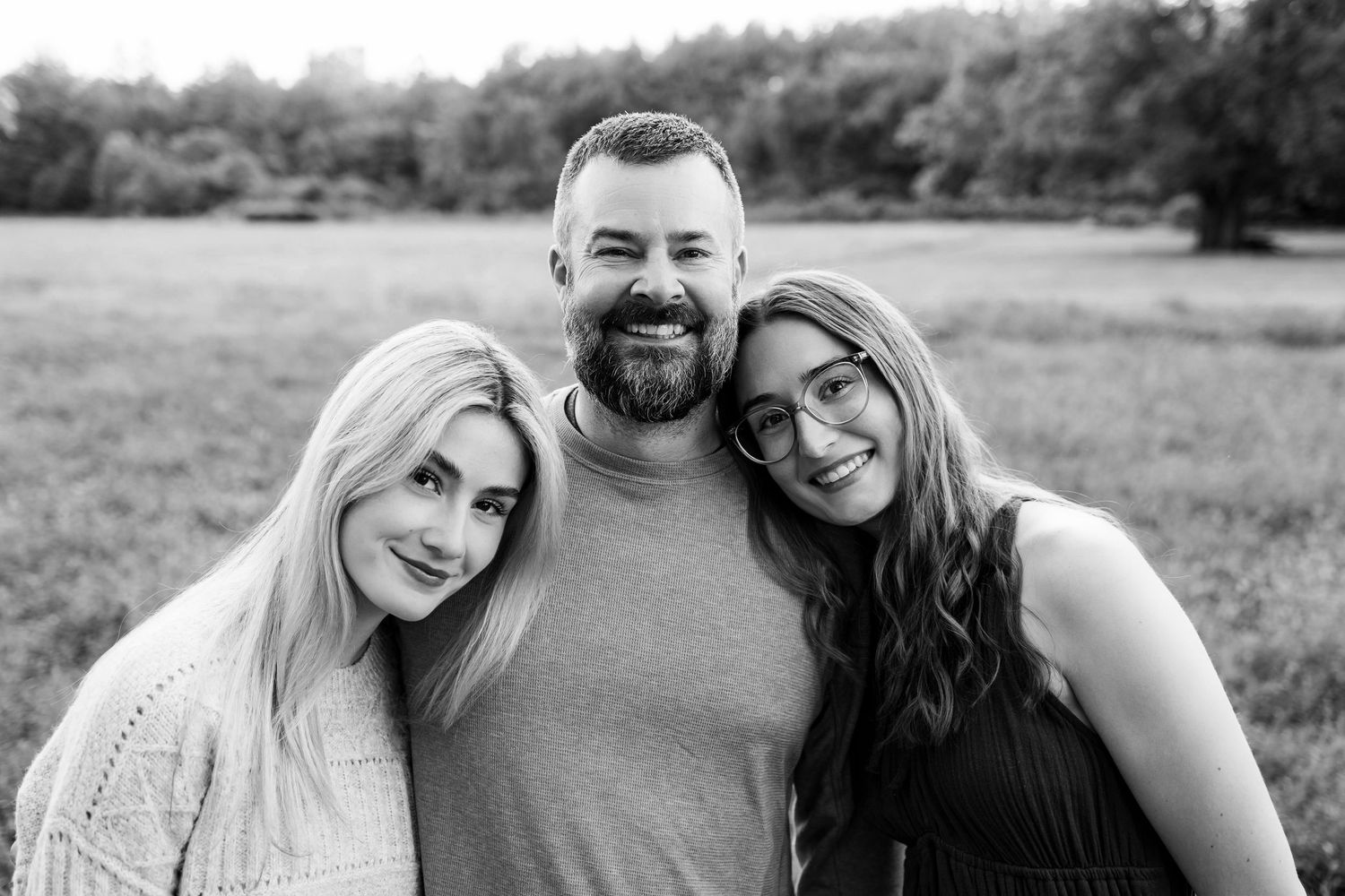 A series of black and white outdoor portraits showing a couple posing together in a natural setting.