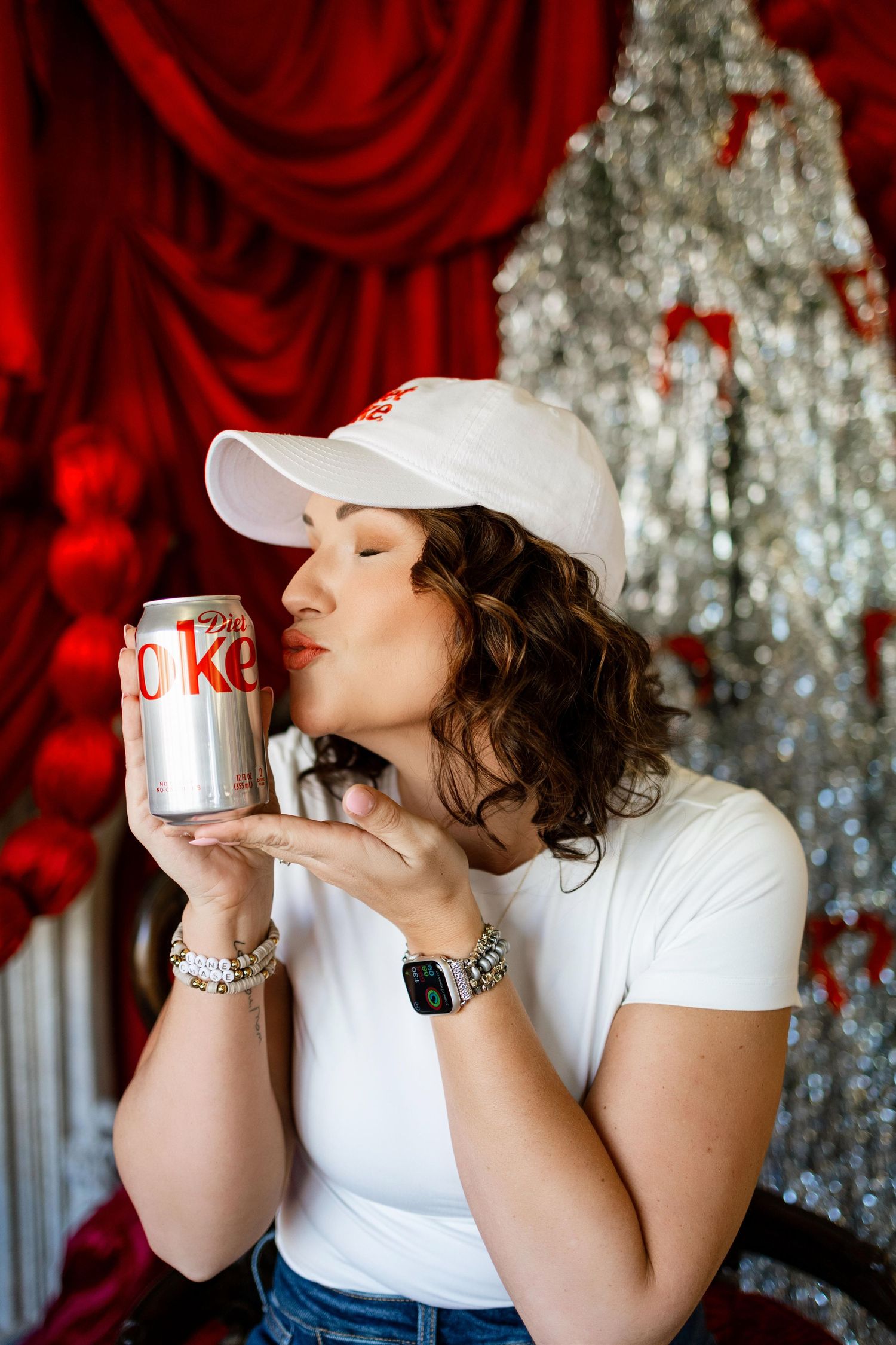 Lifestyle photo with Diet Coke can against sparkly silver backdrop and red drapery.