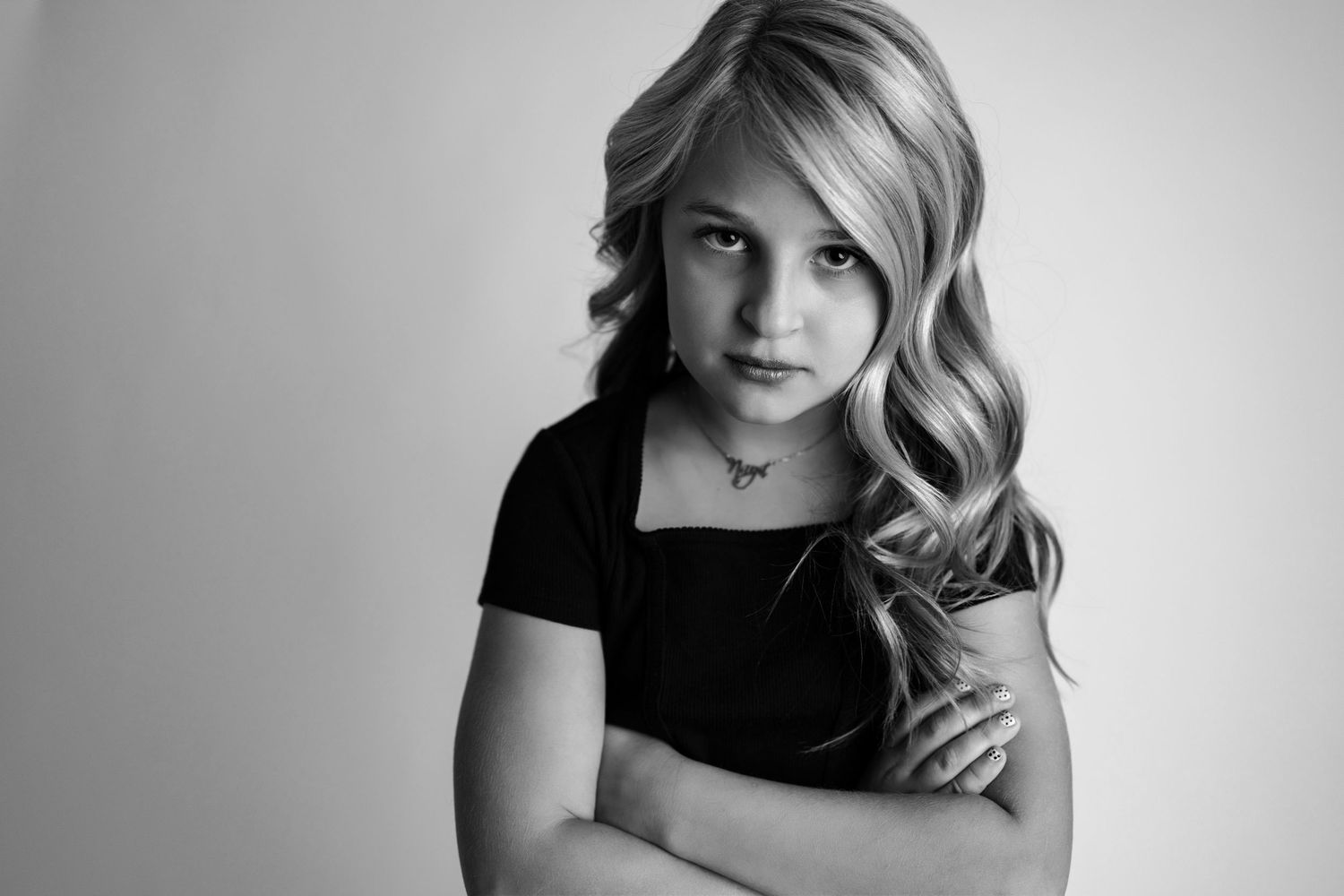 A series of black and white portrait photographs showing elegant poses and soft lighting effects.