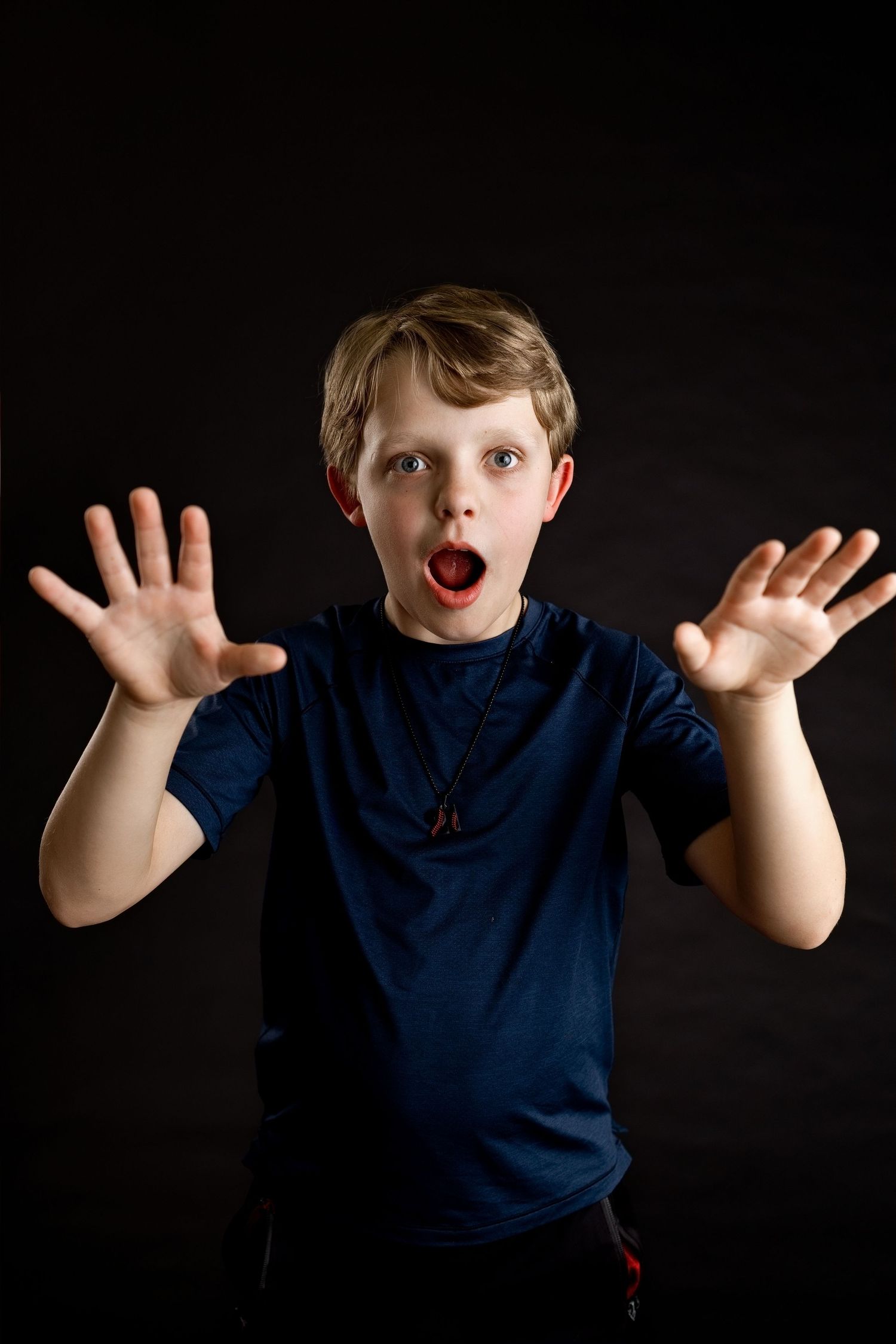 Young boy making a playful expression during a personality-filled studio photography session at TLP