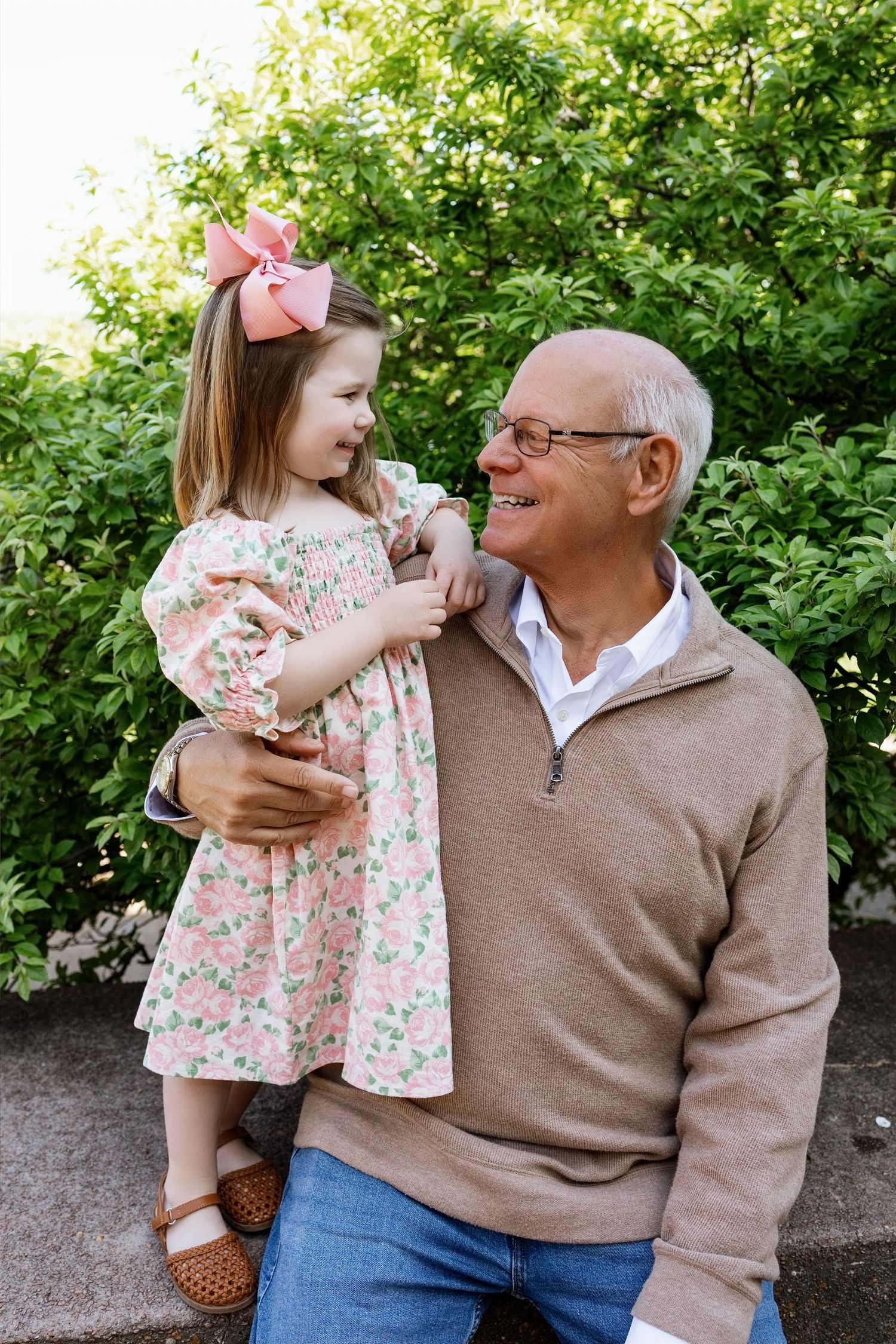 Grandfather holding his granddaughter during a candid family portrait session in the Edwardsville area