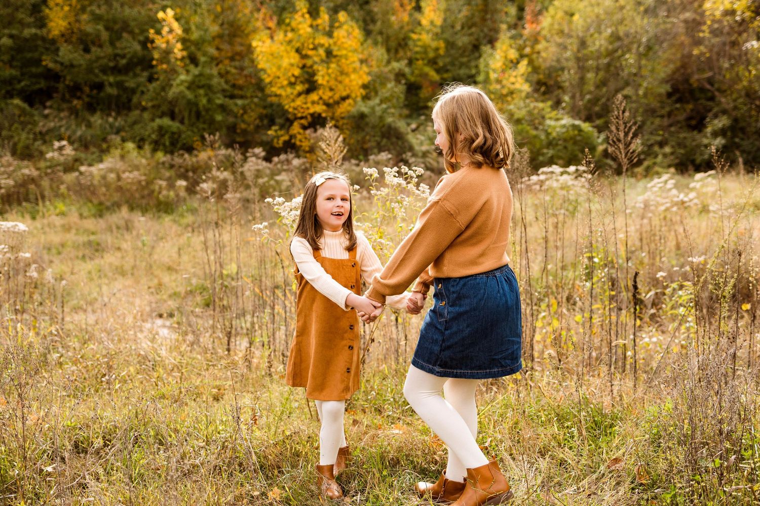 People share joyful moments together in a golden autumn field during sunset.