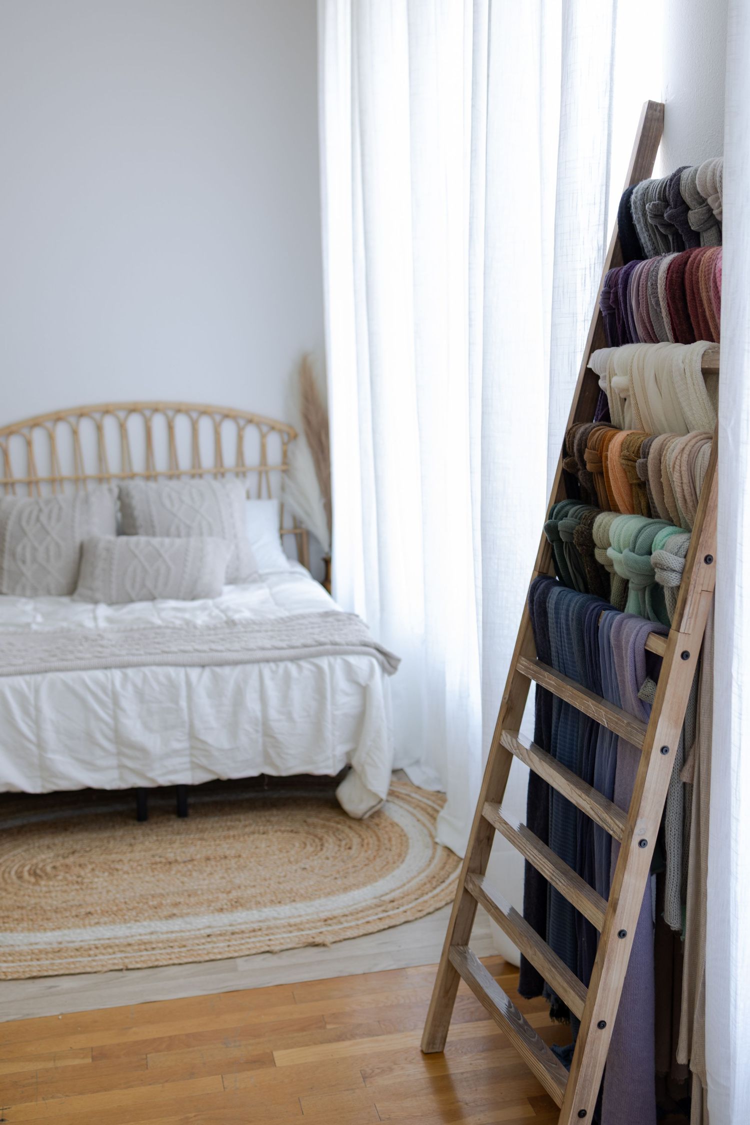 Lifestyle photography area with a rattan bed and colorful blanket collection inside the TLP studio