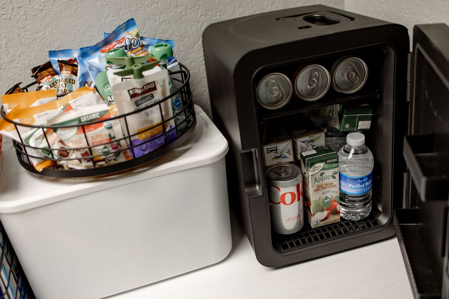 A cluttered kitchen counter with various food items, appliances, and storage containers spread across the surface.