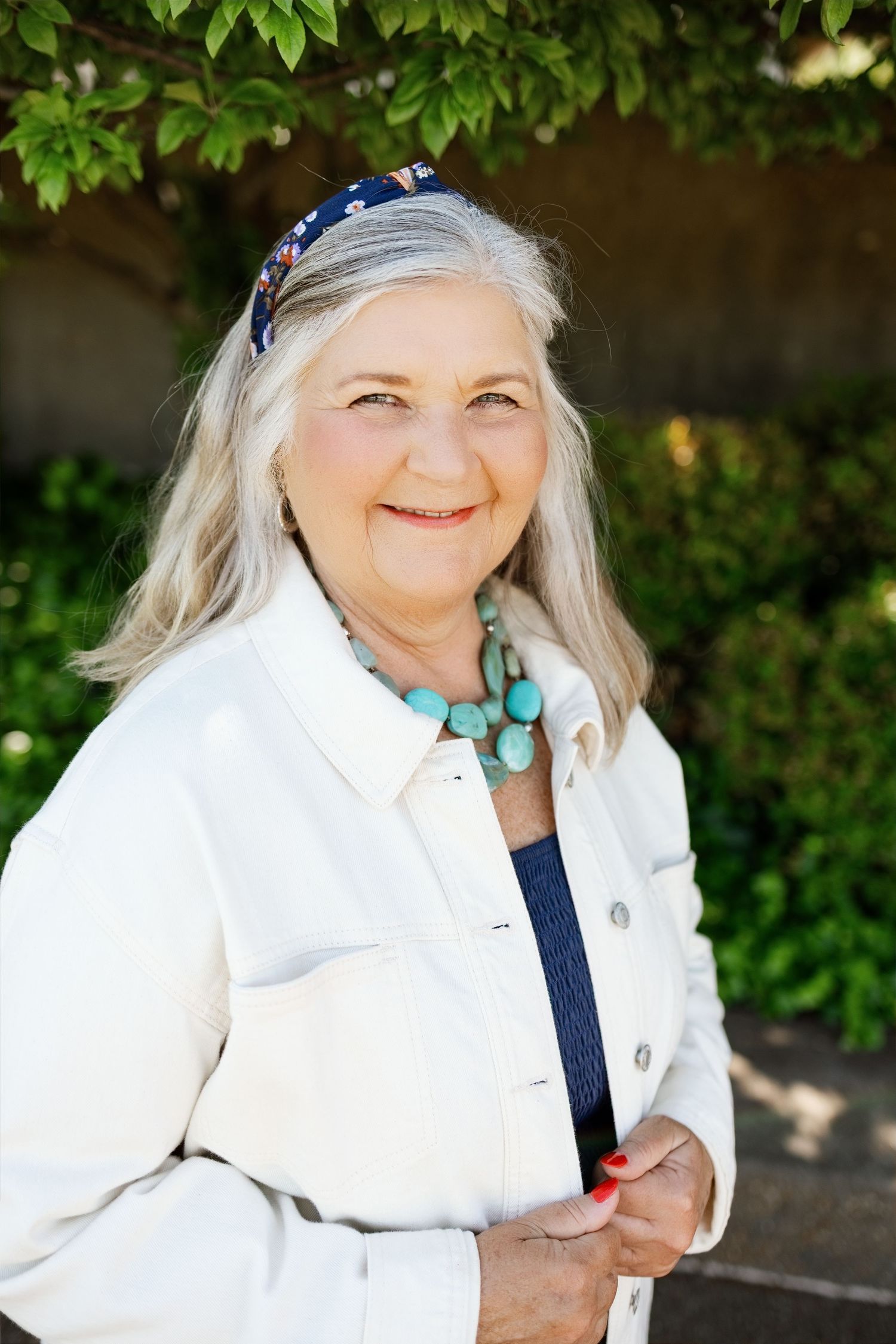 Individual outdoor portrait of a smiling woman captured during an extended-family photography session
