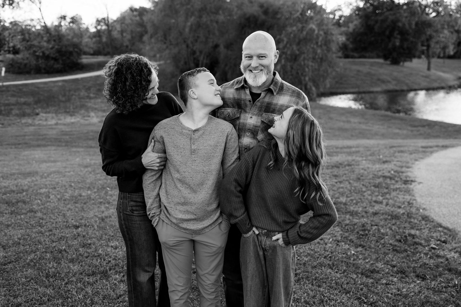 Black and white candid photos show people walking and interacting outdoors in a park-like setting near a pond.