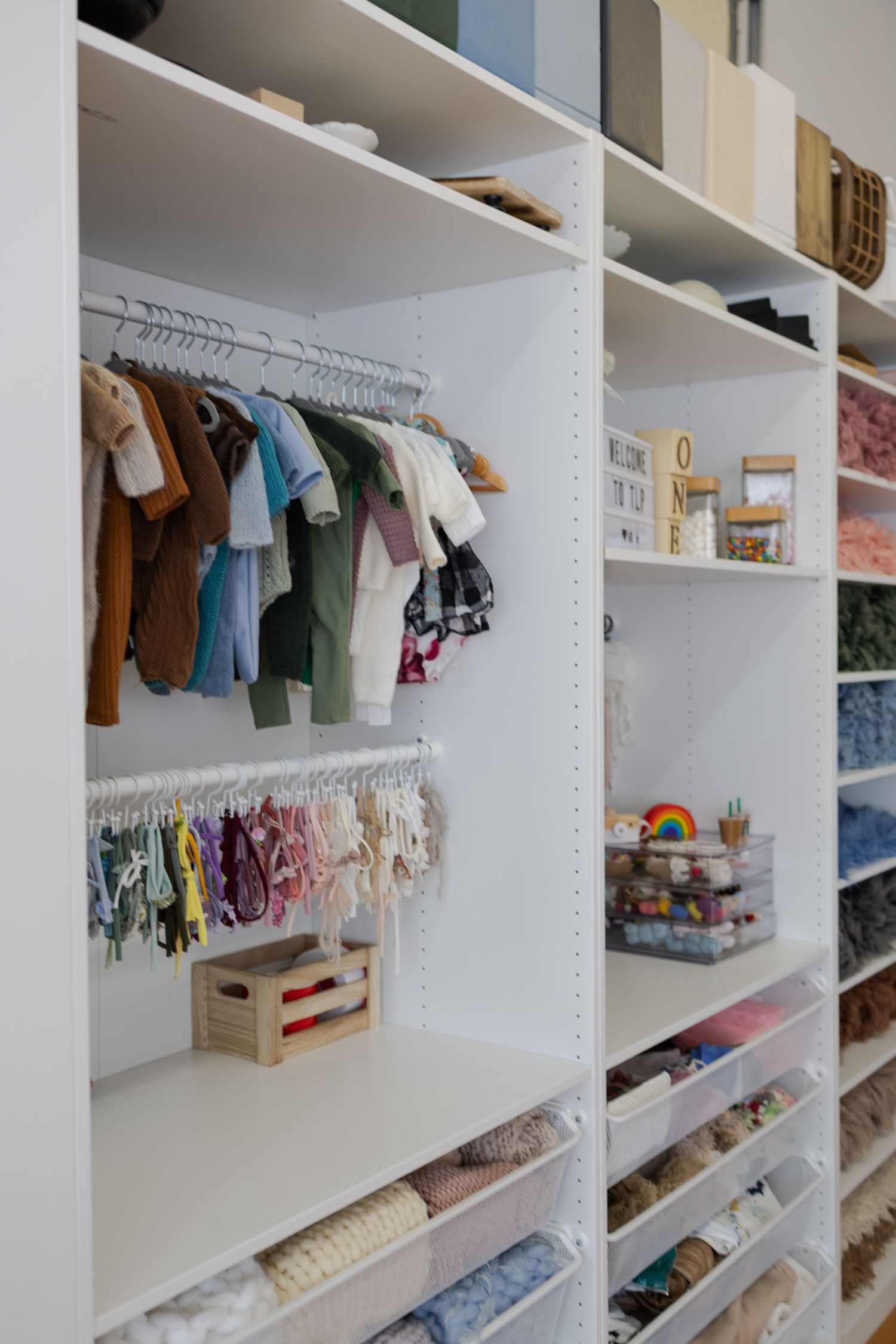 Organized newborn outfits, wraps, props, and styling pieces inside Tara Lee Photography’s Edwardsville studio
