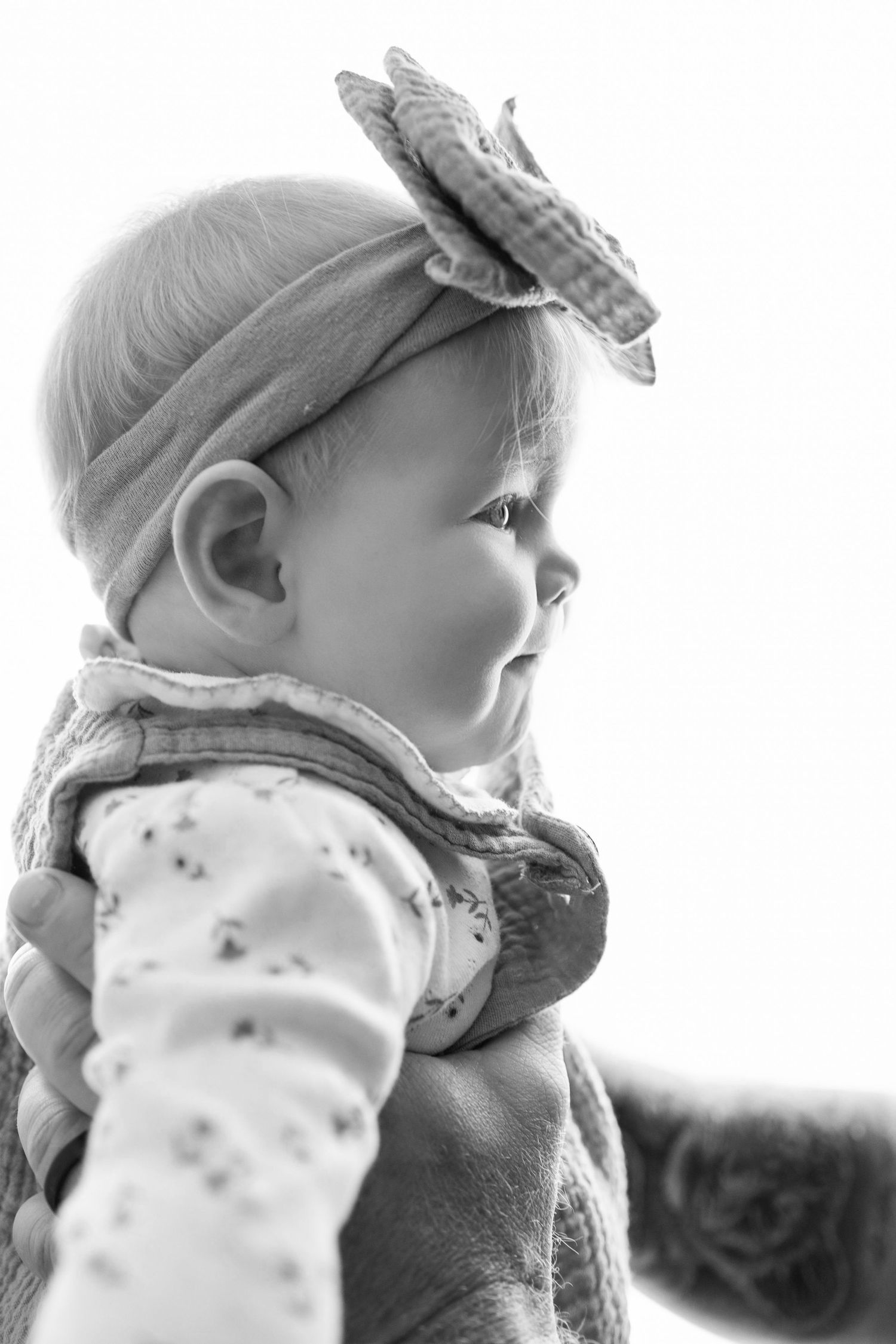 Black and white close-up profile shots of a baby wearing a hat in different angles.