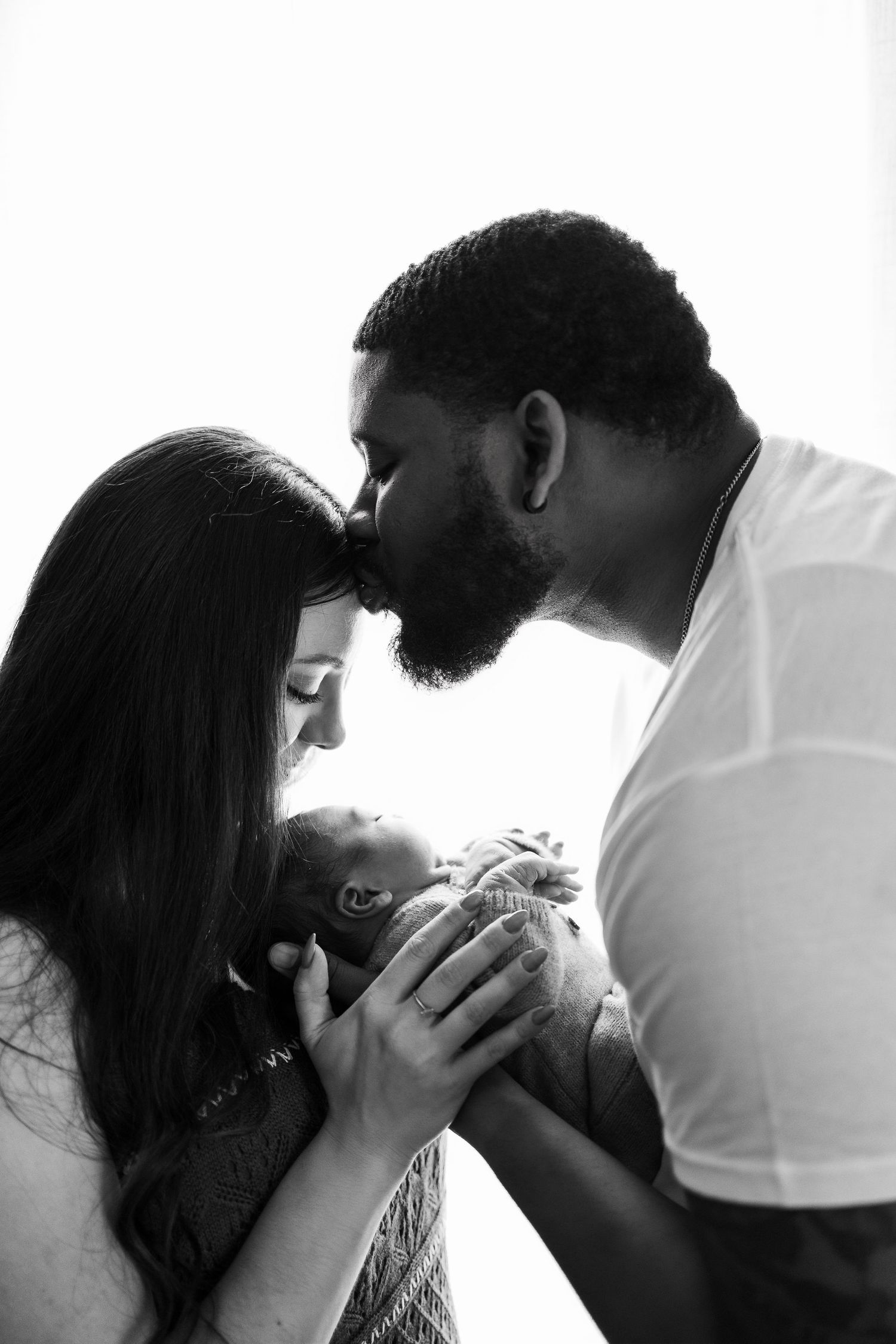 A series of intimate black and white photographs showing tender romantic moments between a couple.