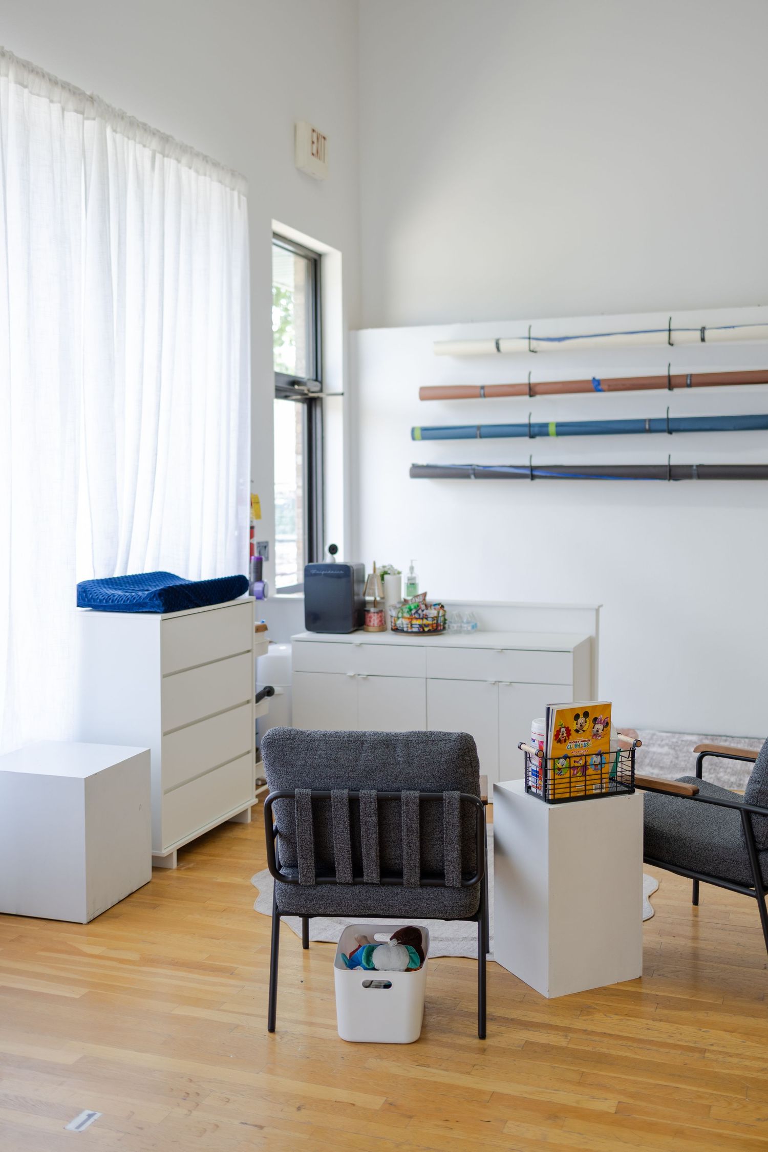 Bright studio preparation area with client seating, storage, and photography equipment at TLP