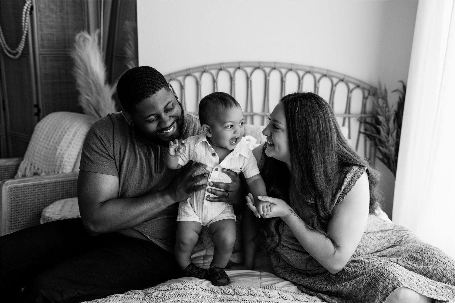 Family laughing with their baby during a milestone photography session at Tara Lee Photography in Edwardsville, Illinois