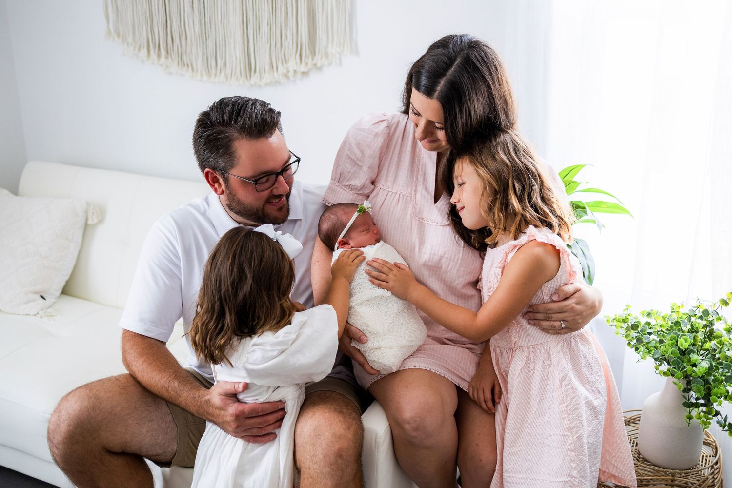 A romantic collection of intimate lifestyle photos showing tender moments between a couple in a bright white setting.