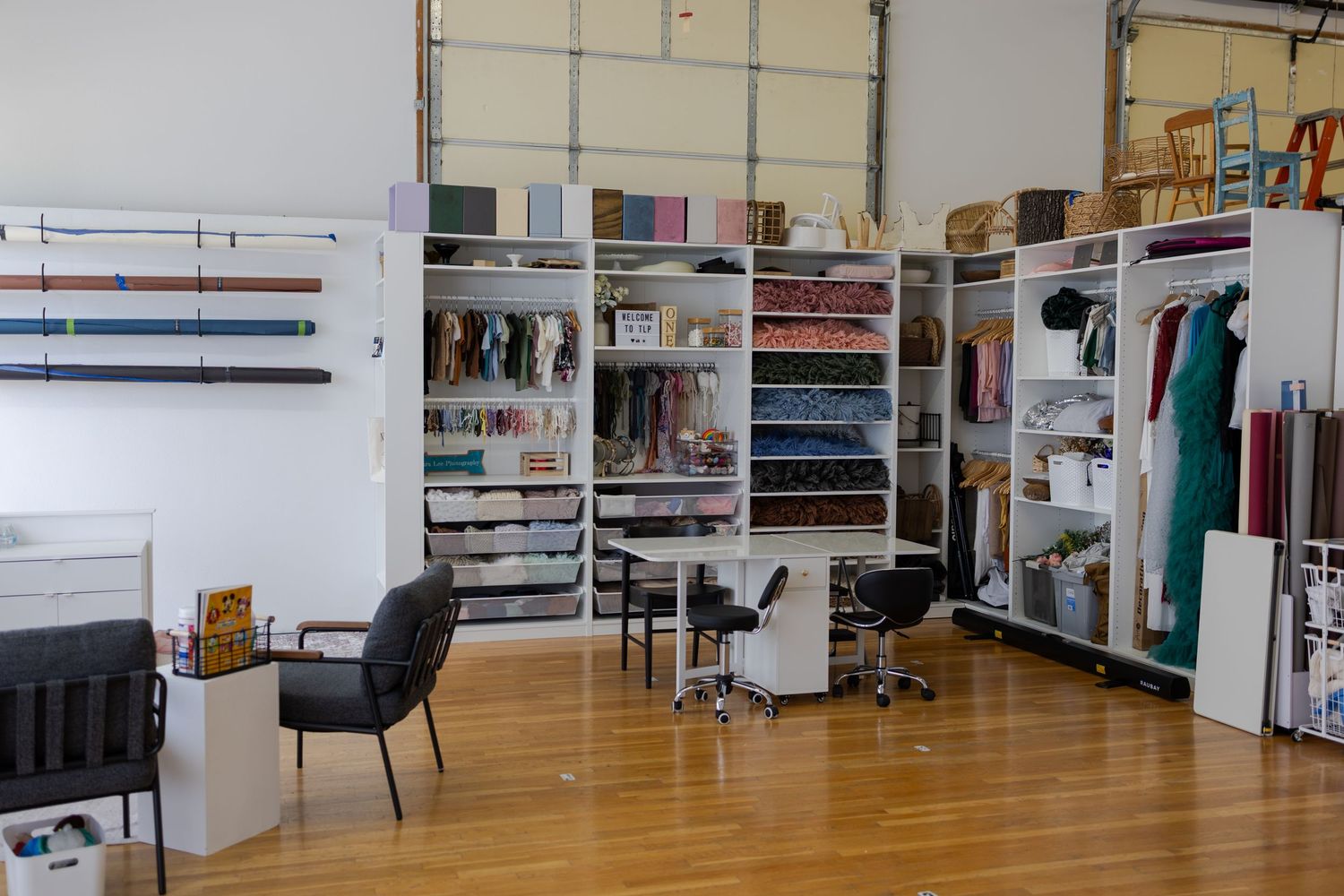 Interior of the TLP photography studio featuring organized props, backdrops, and session styling supplies in Edwardsville