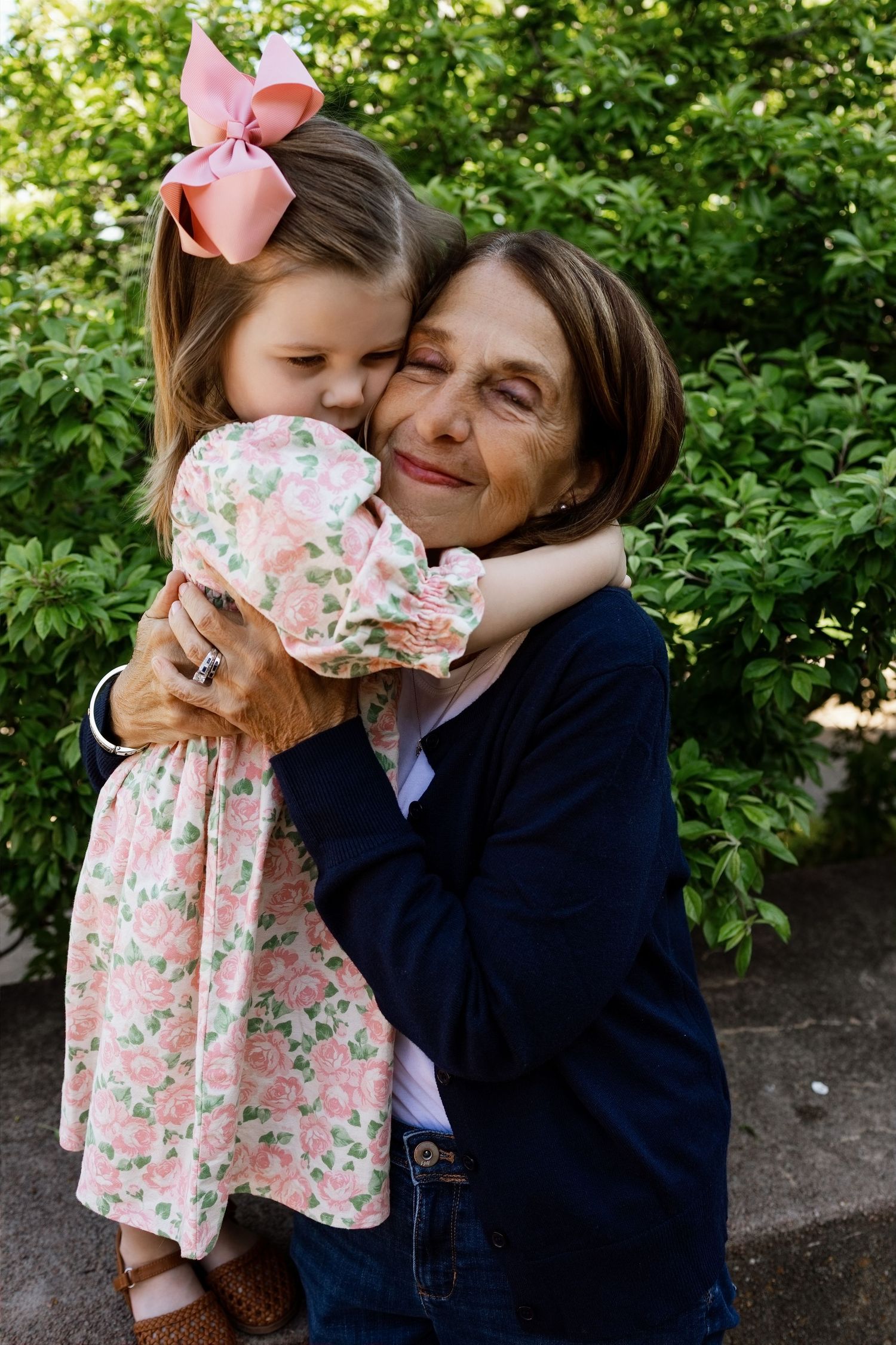 Grandmother hugging her granddaughter during a multigenerational family photography session in the Metro East area