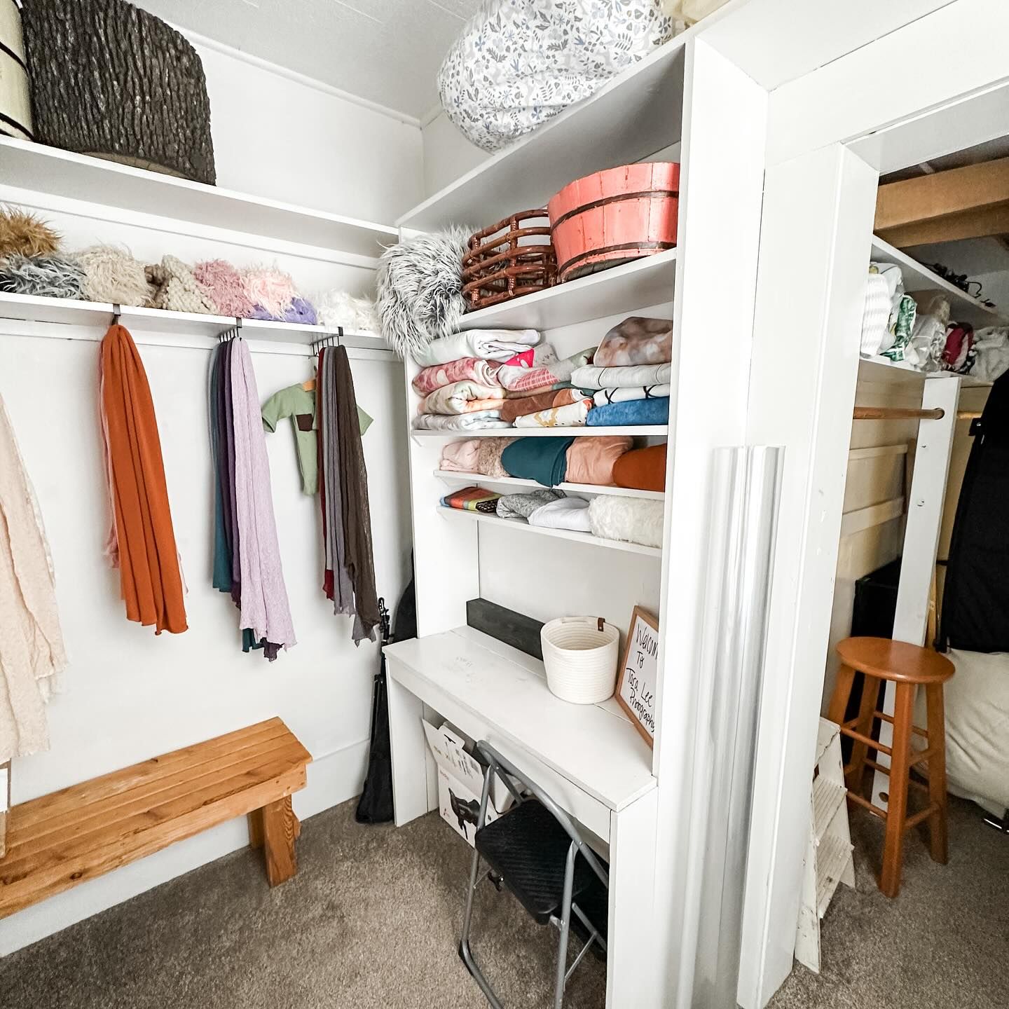 Organized closet with shelving displaying clothing, accessories and storage solutions.