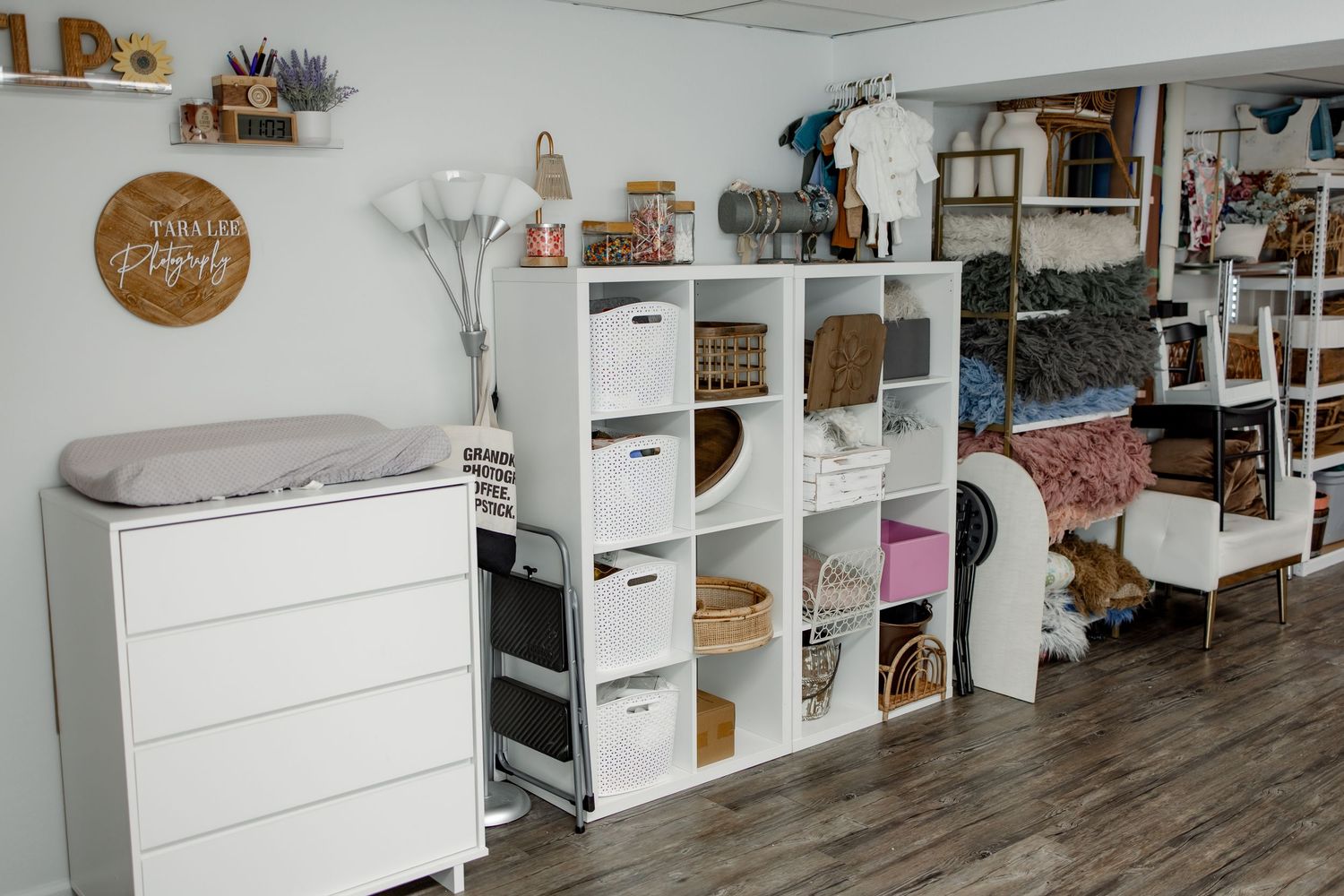 White storage cubes with drawers arranged in a row along a wall create an organized retail display space.