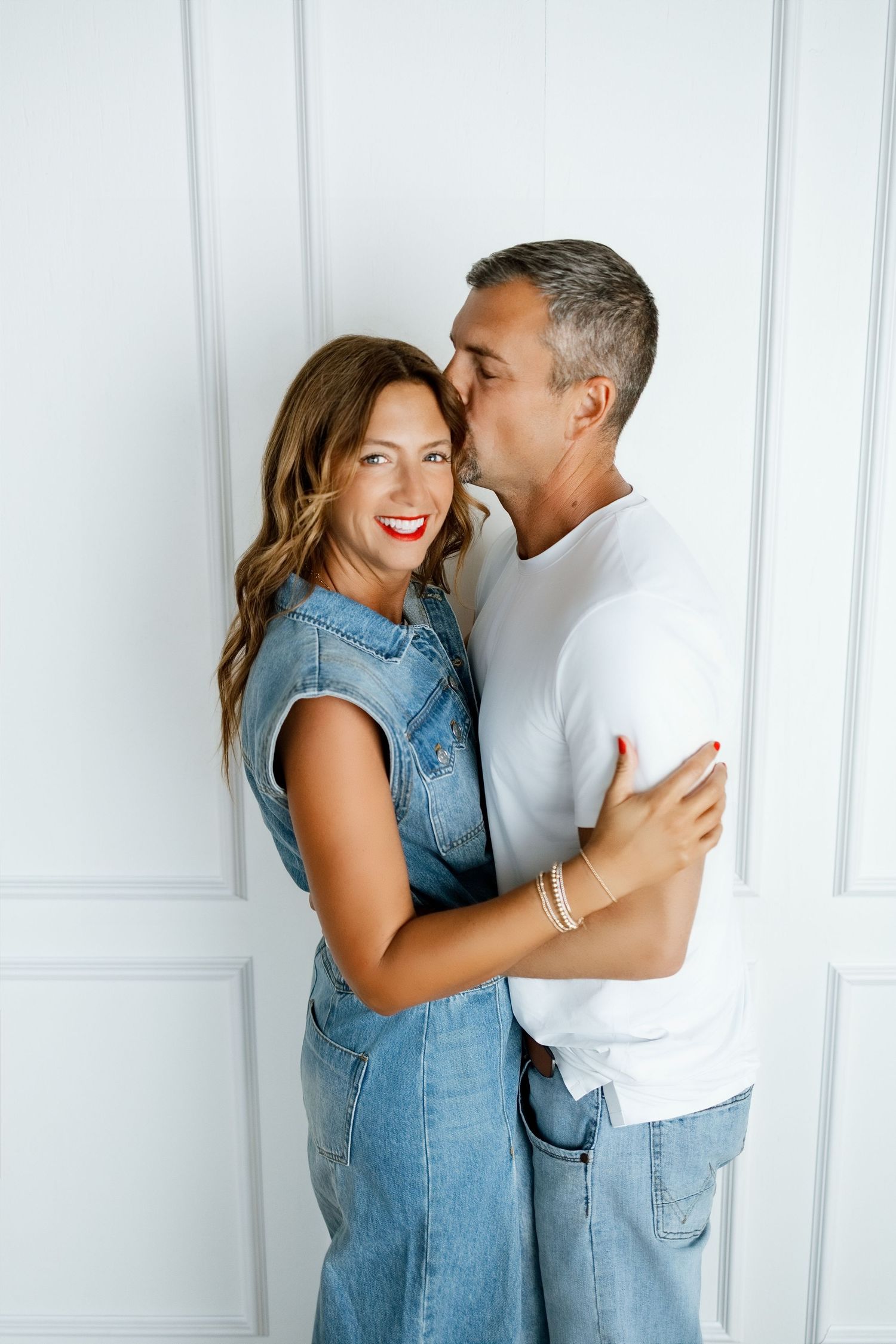 Podcasting couple sharing a candid moment during a relaxed lifestyle branding session at the TLP studio