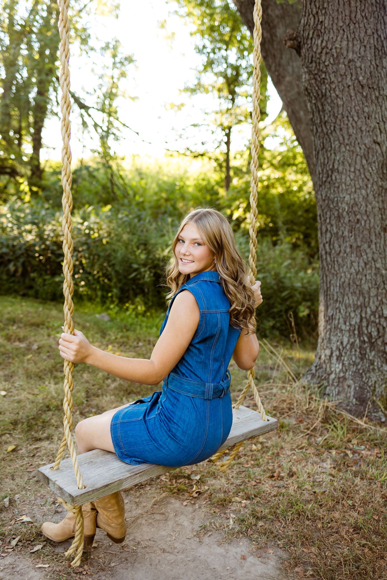 Three artistic outdoor photos of someone wearing a blue dress enjoying a rustic wooden rope swing in a sunlit forest.