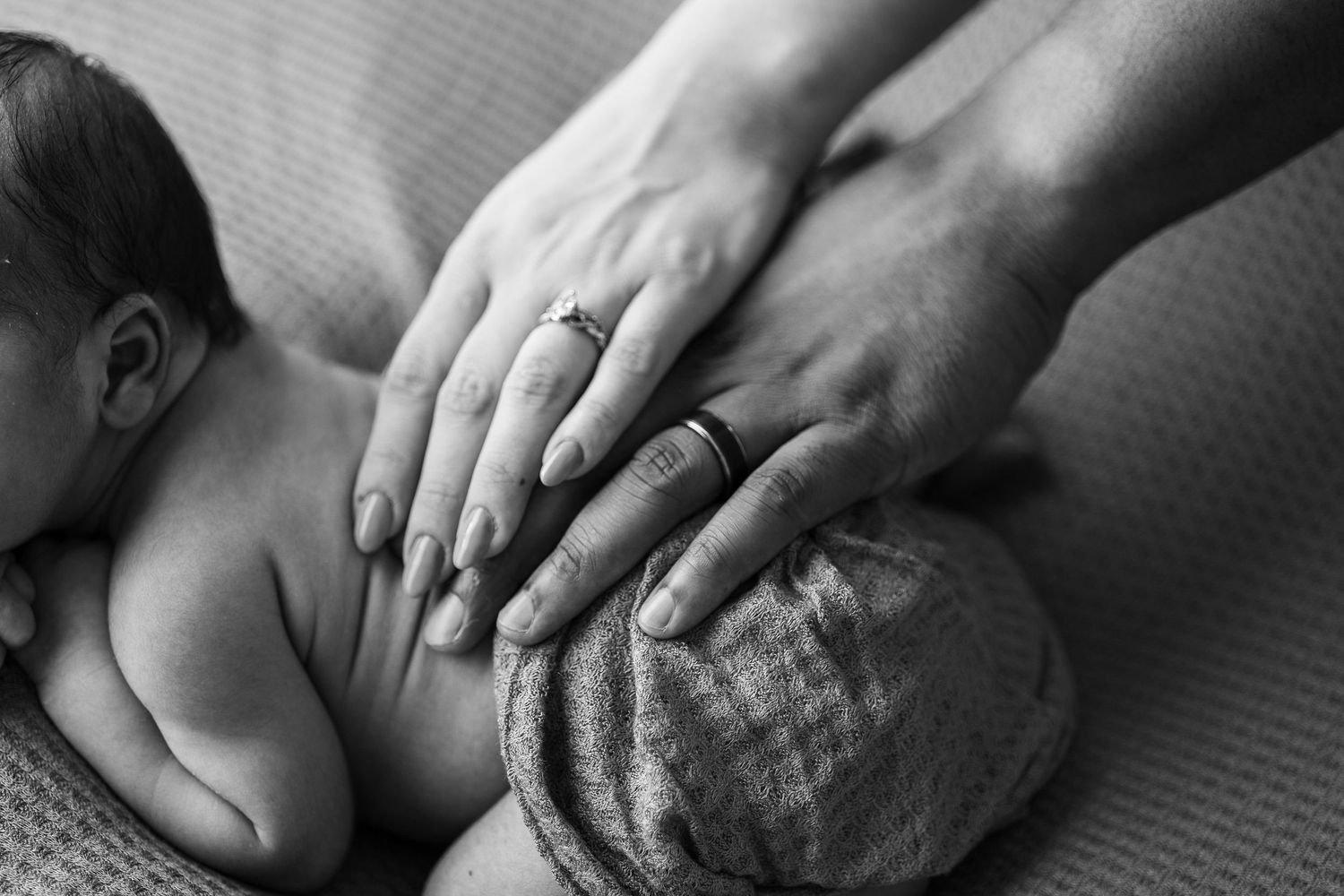 Black and white photo series of sensual massage therapy techniques showing hands kneading muscles and skin.
