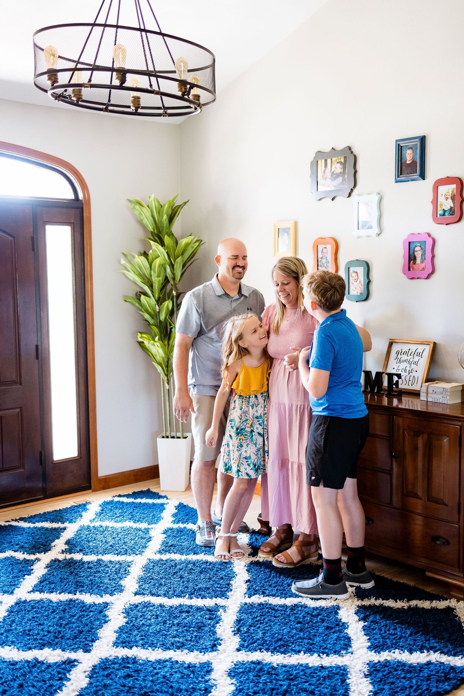 A sequence of candid family moments in a modern living room with a blue and white geometric rug.