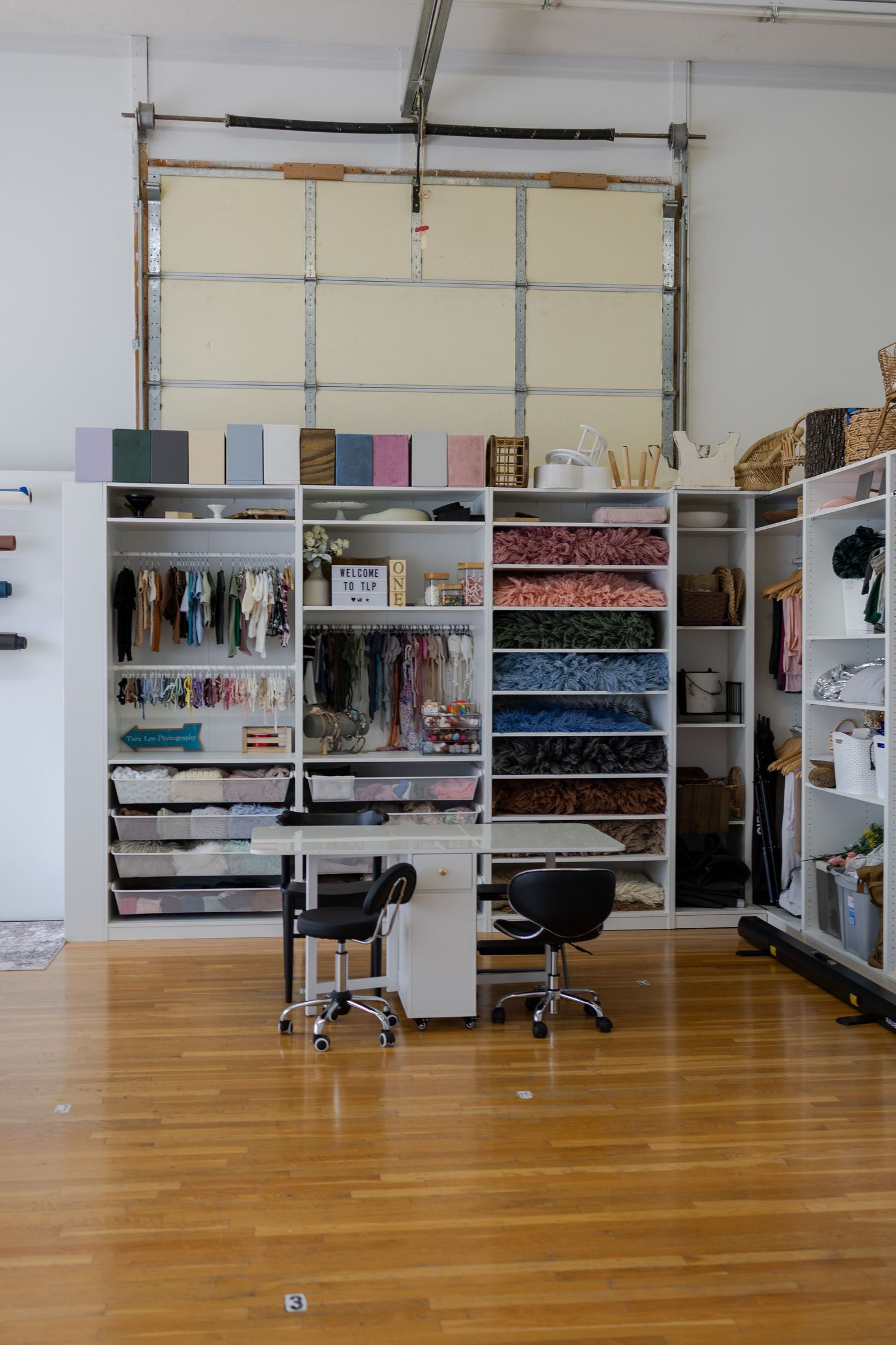 Interior view of the Edwardsville photography studio with organized backdrops, props, and session styling pieces