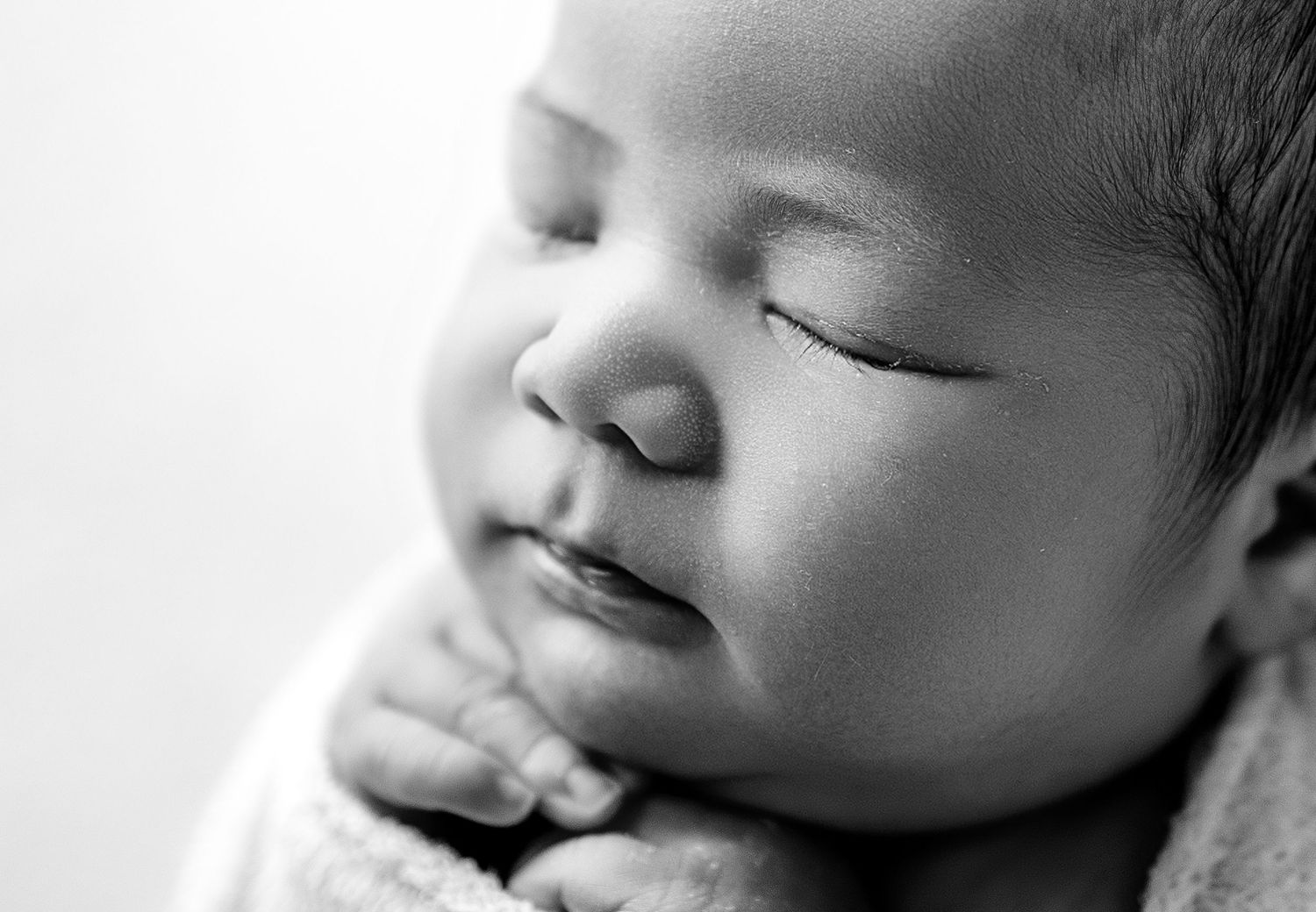 Close-up black and white portrait showing peaceful sleeping expressions.
