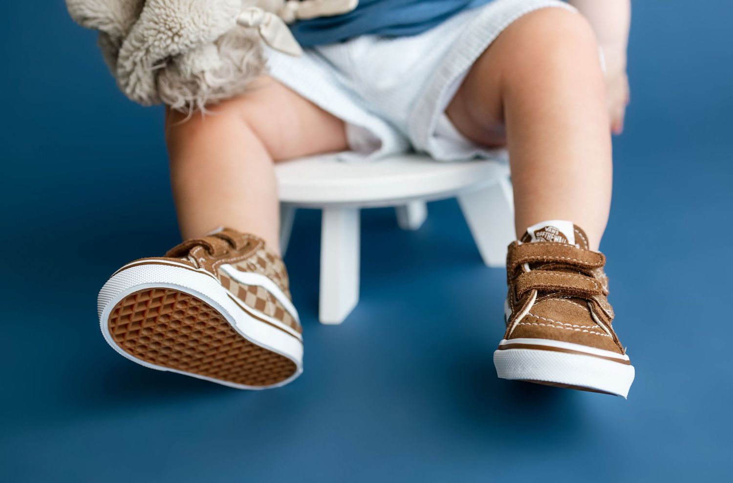 Toddler wearing brown sneakers during a colorful milestone photography session in an Edwardsville studio