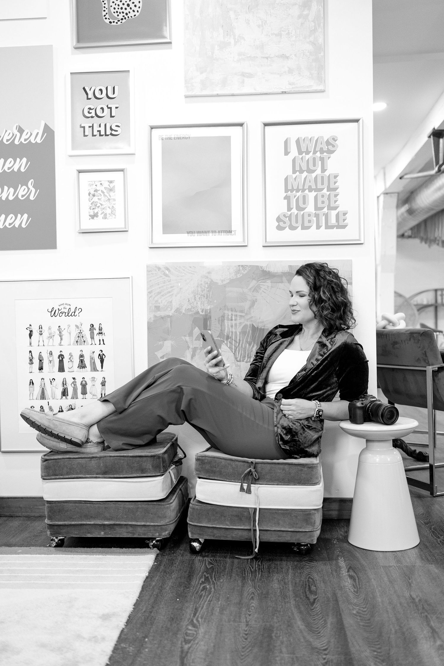 A black and white photo series showing a person reclining on a couch in a gallery space with framed artwork on the walls.