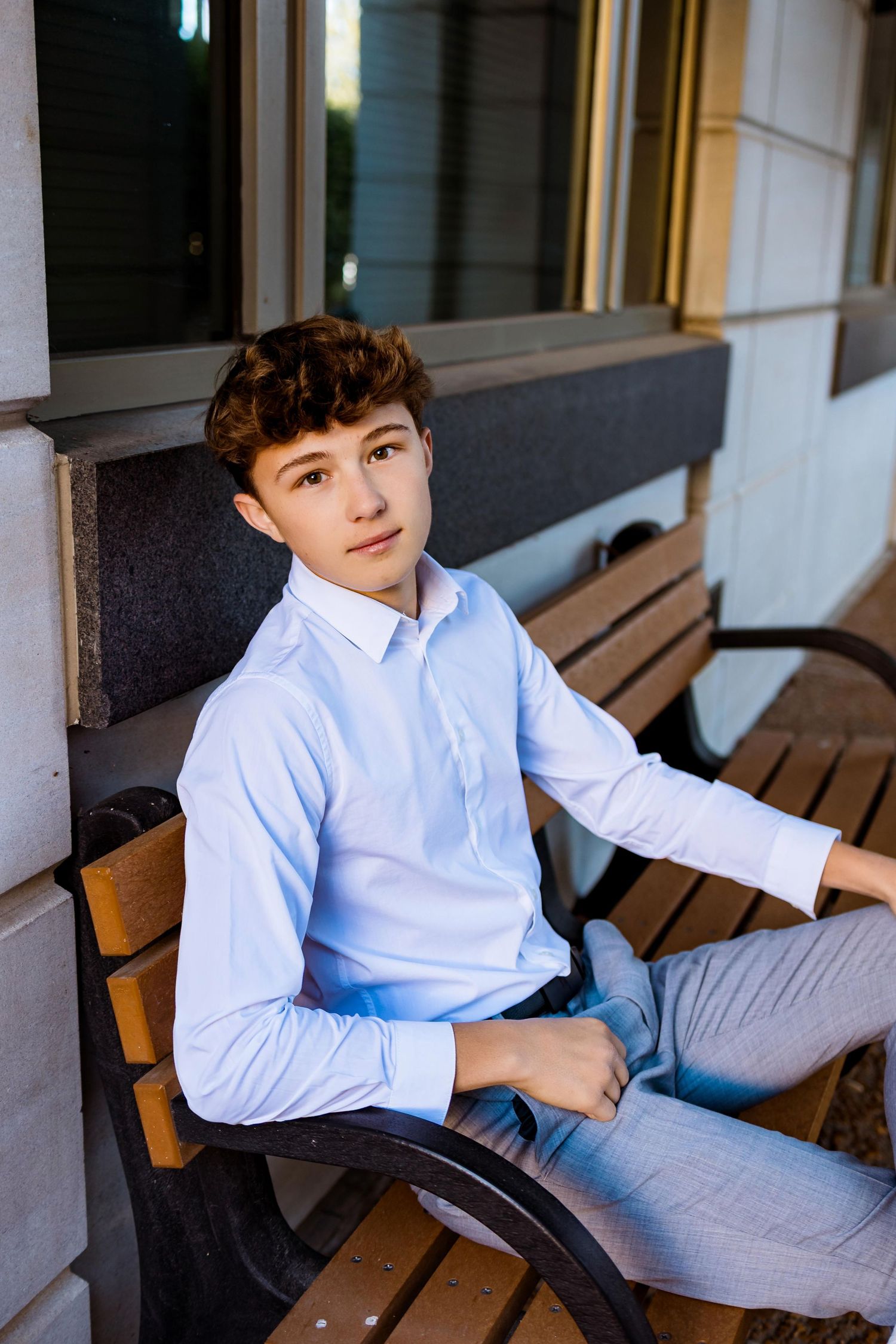 A set of casual portraits on a wooden bench showing someone wearing a light blue button-down shirt and jeans.