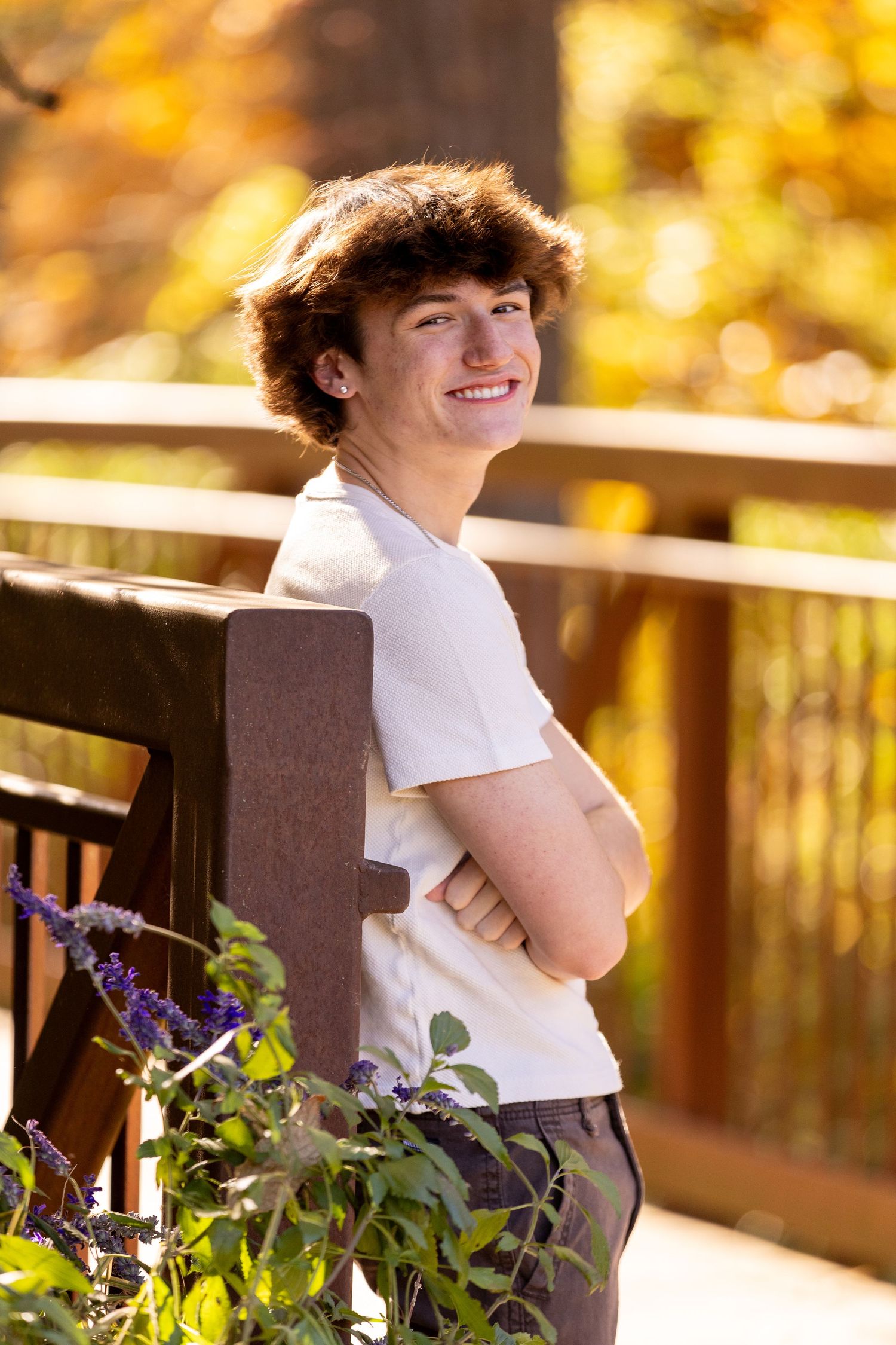 Outdoor portrait in white t-shirt with warm autumn colors in background.