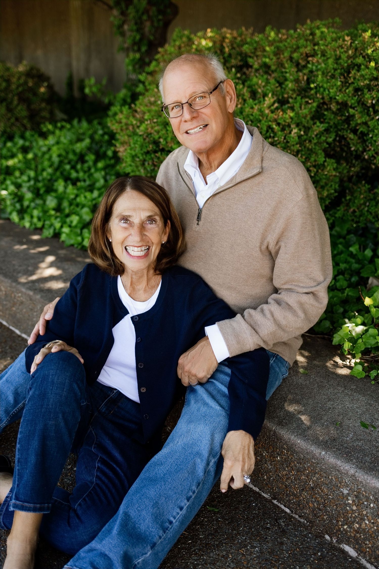 Couple smiling together on outdoor steps during a relaxed family photography session in Southern Illinois
