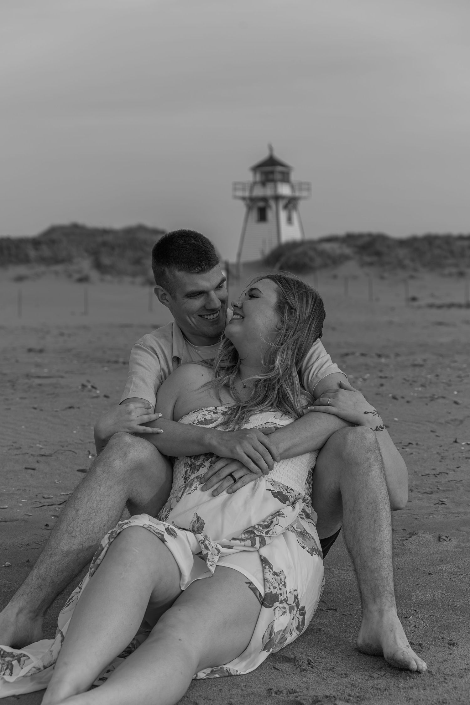 Couple sharing a quiet moment on the beach in Prince Edward Island.