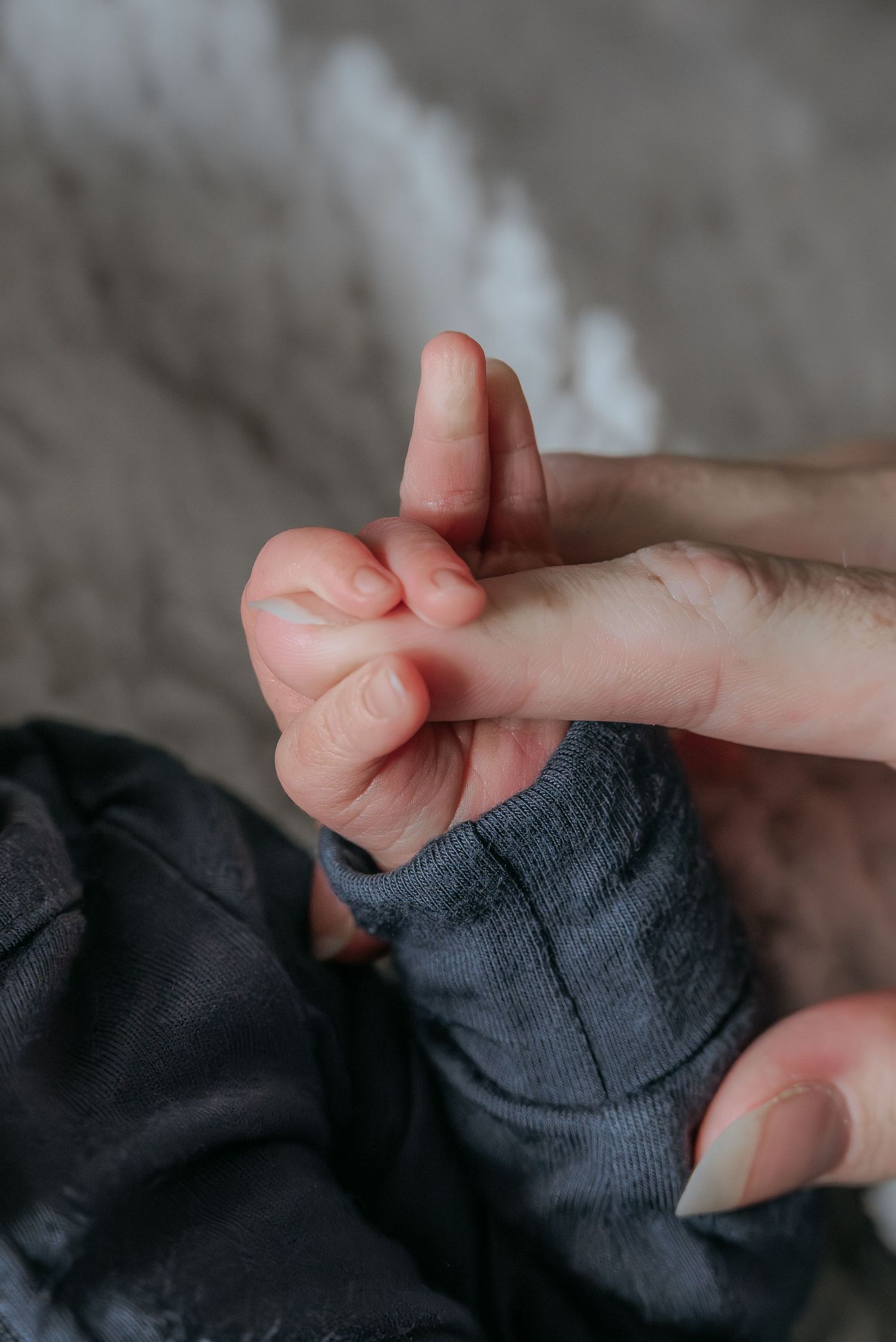 Close-up of newborn baby’s tiny hands and fingers