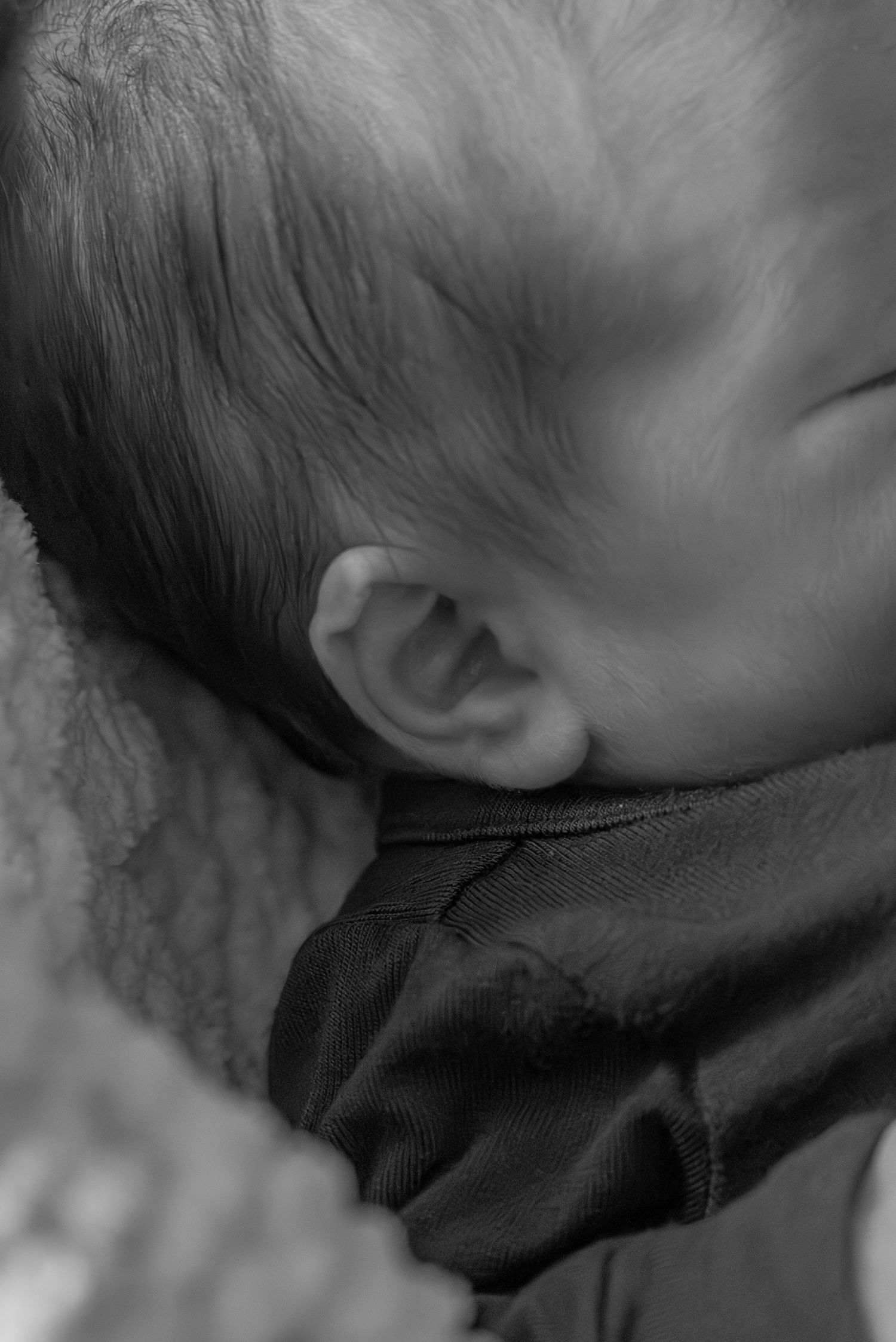 Close-up of newborn baby’s tiny ear