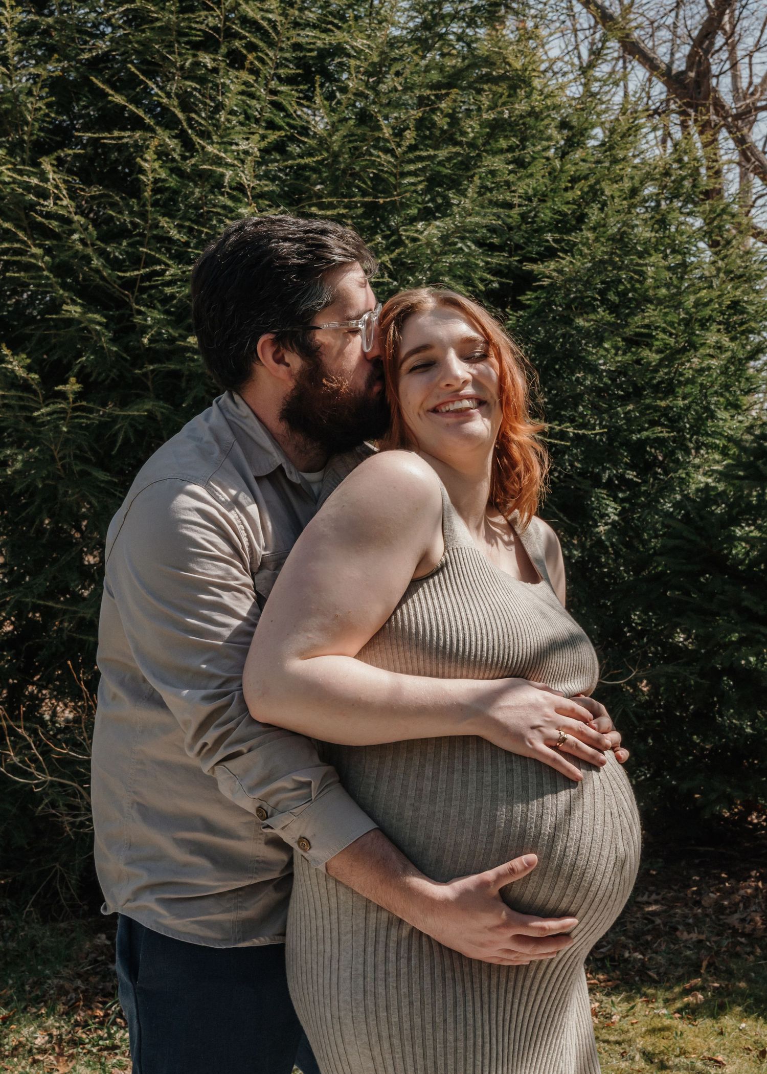 Couple embracing while expecting their baby during maternity session in Prince Edward Island.