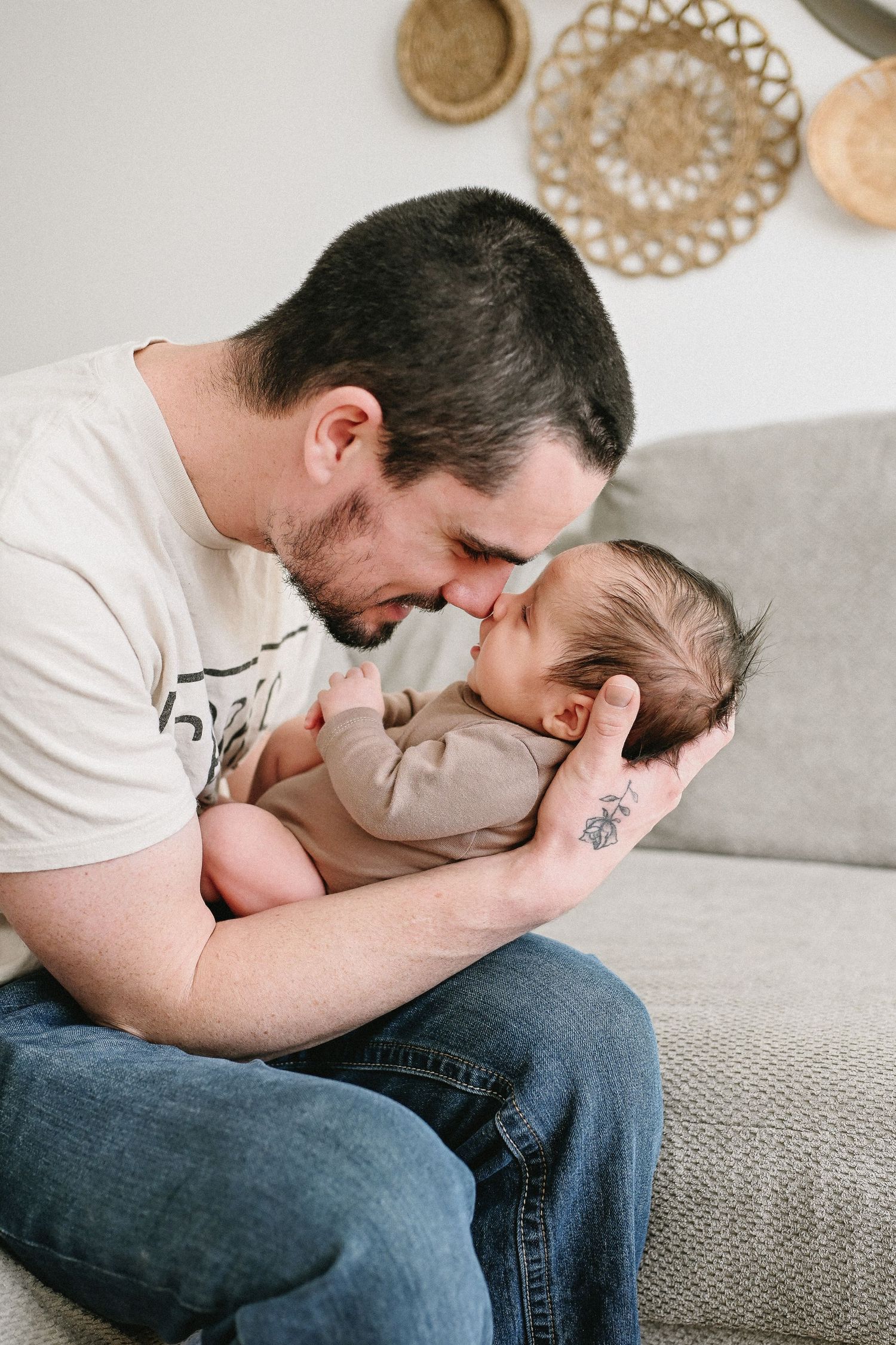 Father holding newborn baby during relaxed in-home newborn session in NS.