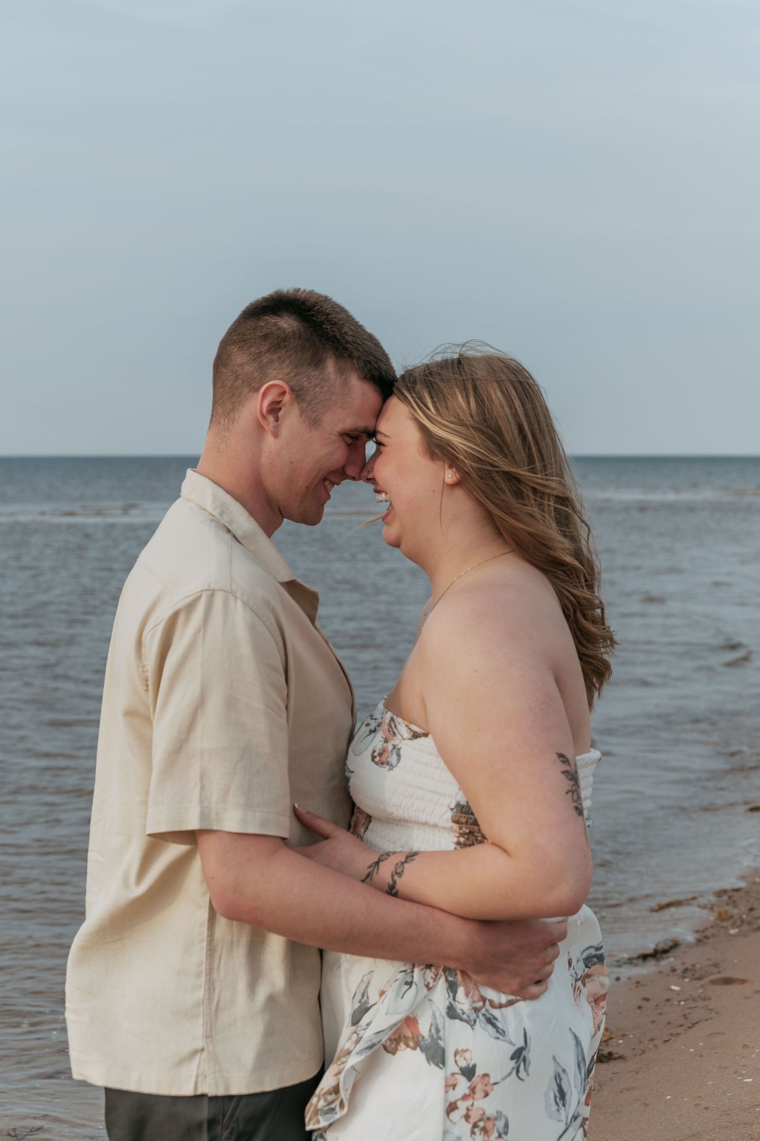 Couple portrait captured on the beach with ocean backdrop in Prince Edward Island.