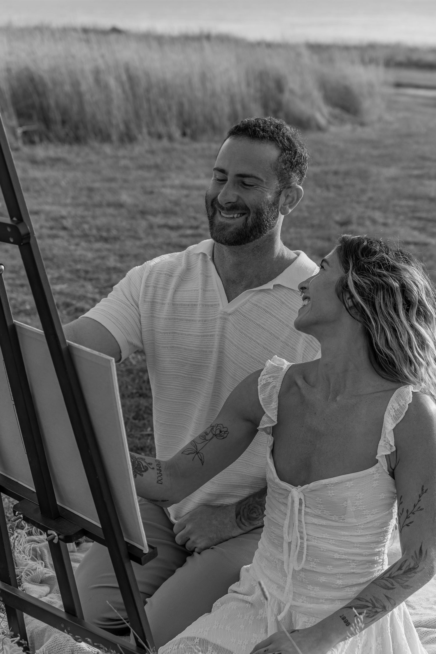 Couple sharing a quiet moment painting in a field