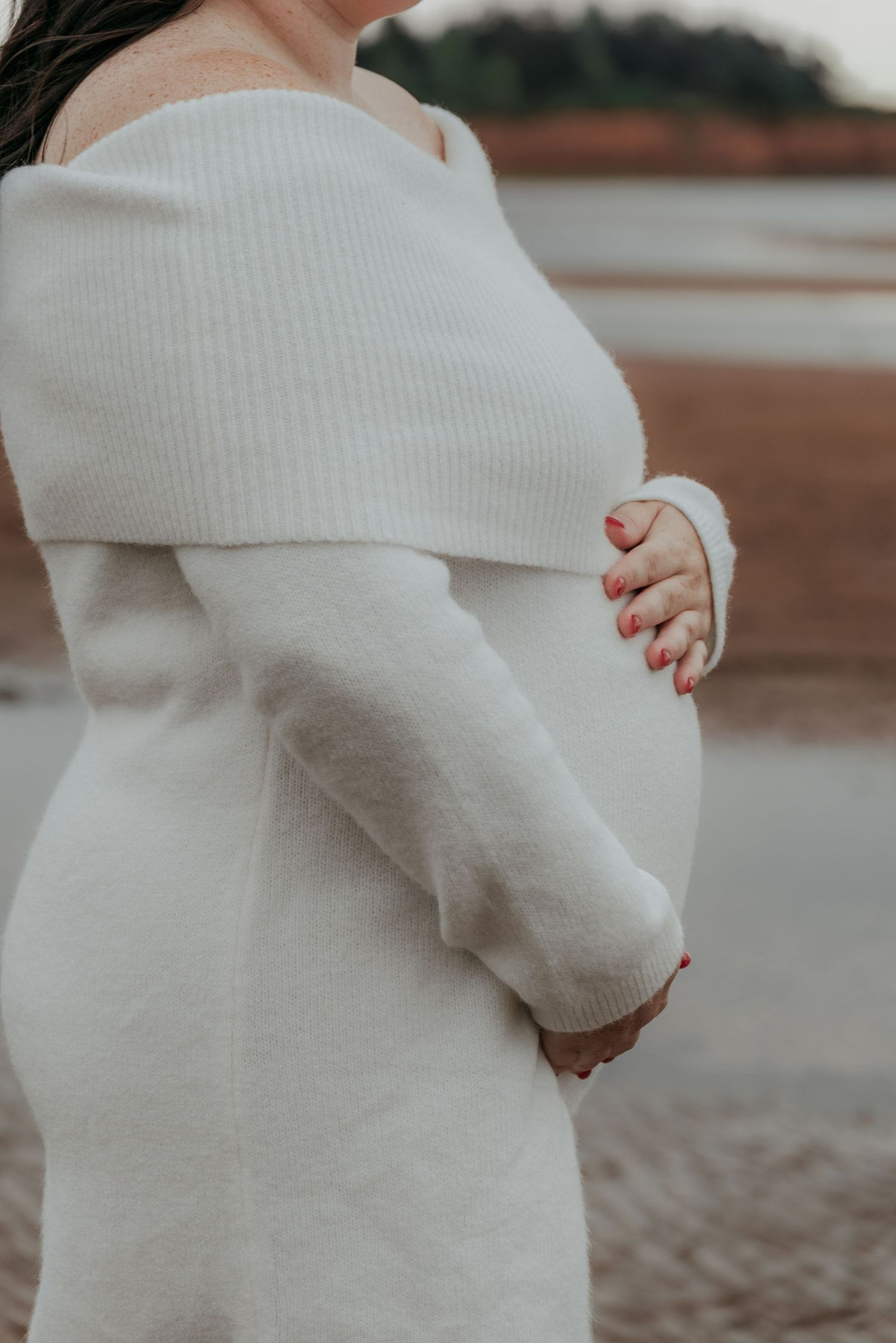 Candid maternity photography on the beach in Prince Edward Island.