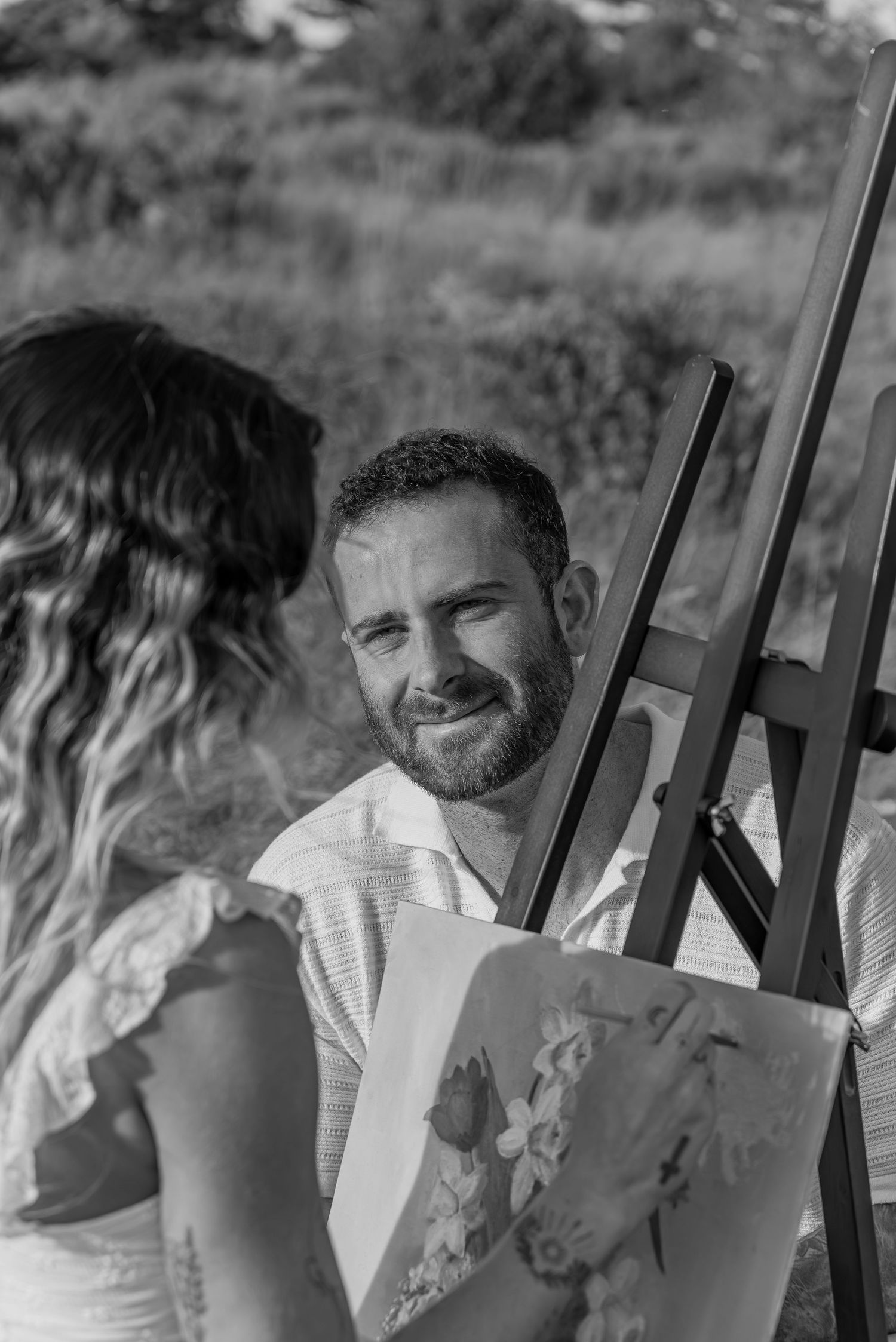 Couple sharing a quiet moment painting in a field