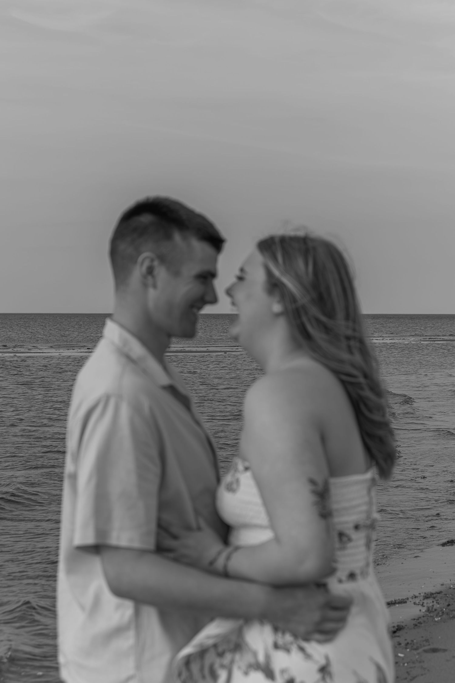 Couple portrait captured on the beach with ocean backdrop