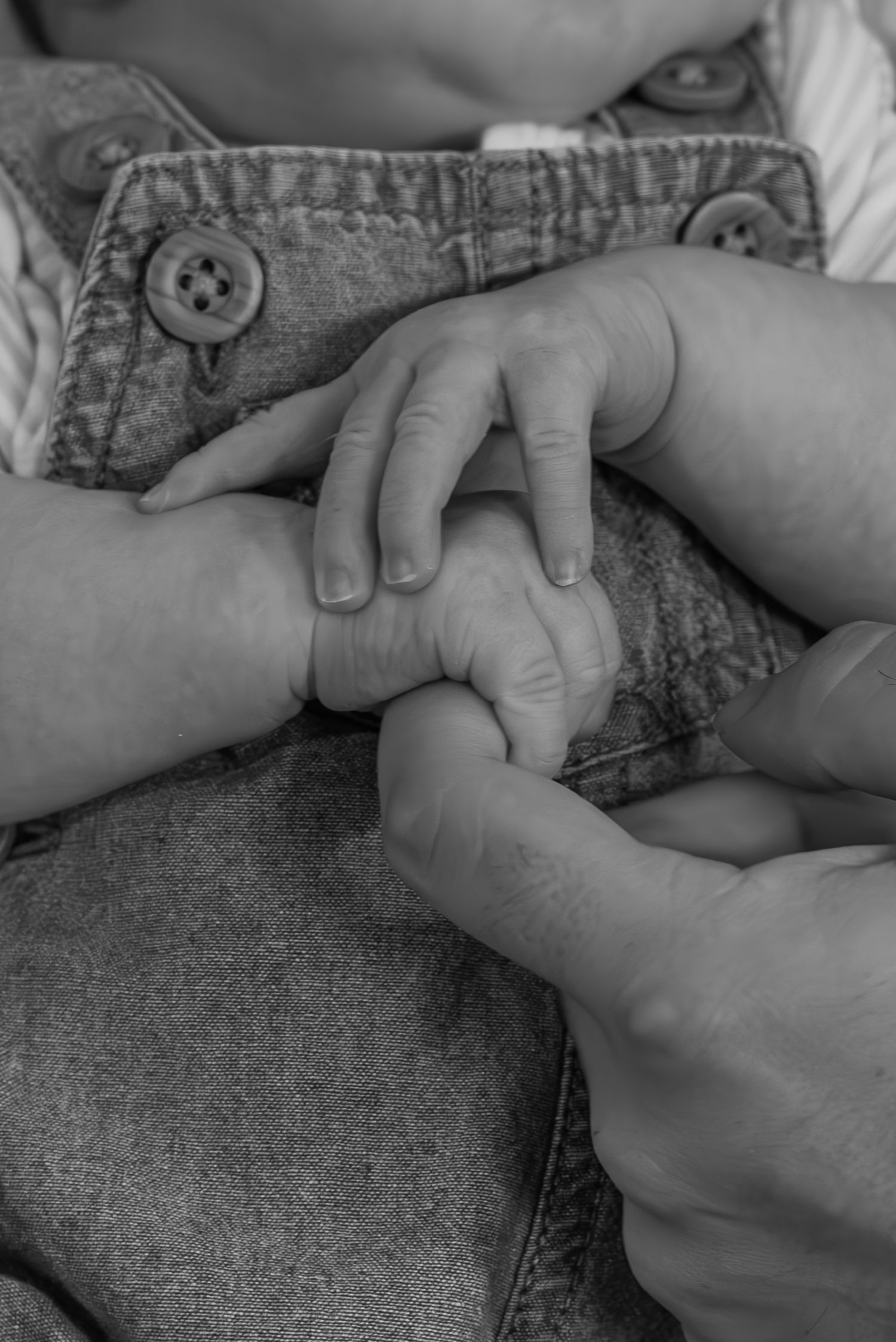 Close-up of newborn baby’s tiny hands and fingers