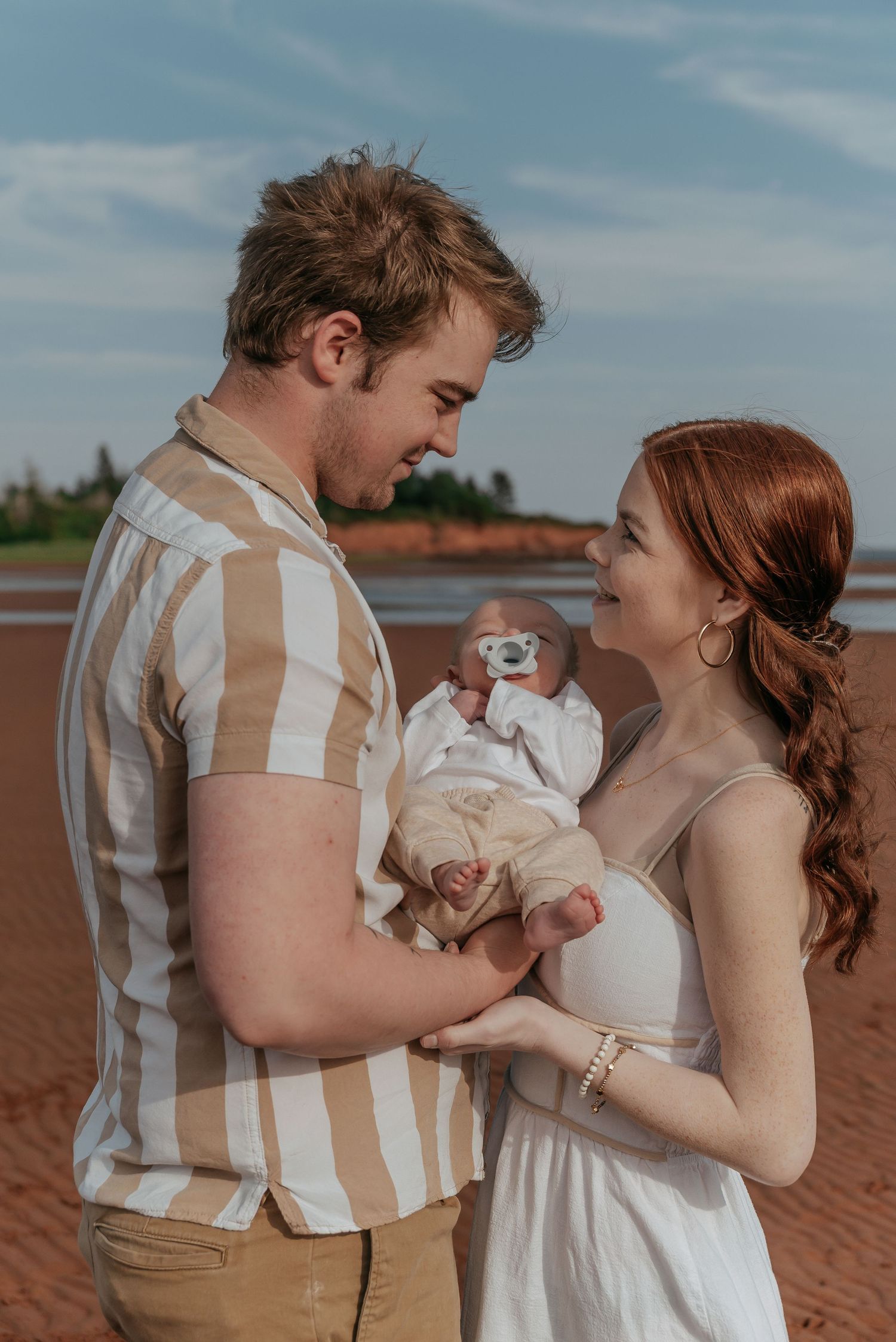 Family photography session capturing parents and children together on PEI beach.
