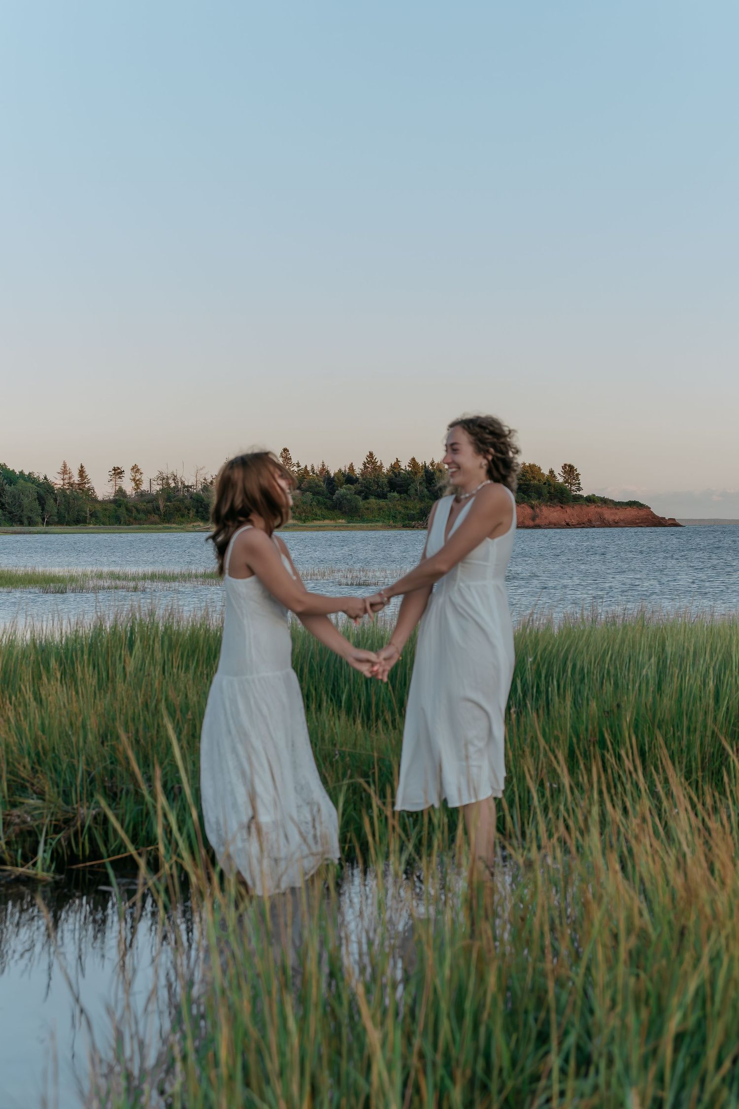 Friends dancing on a Prince Edward Island beach, shot by Madison Clark.